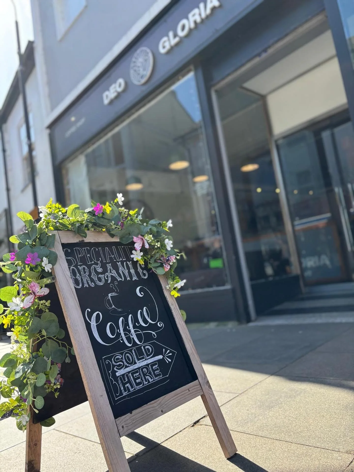 Sandwich board advertising organic coffee sold here
