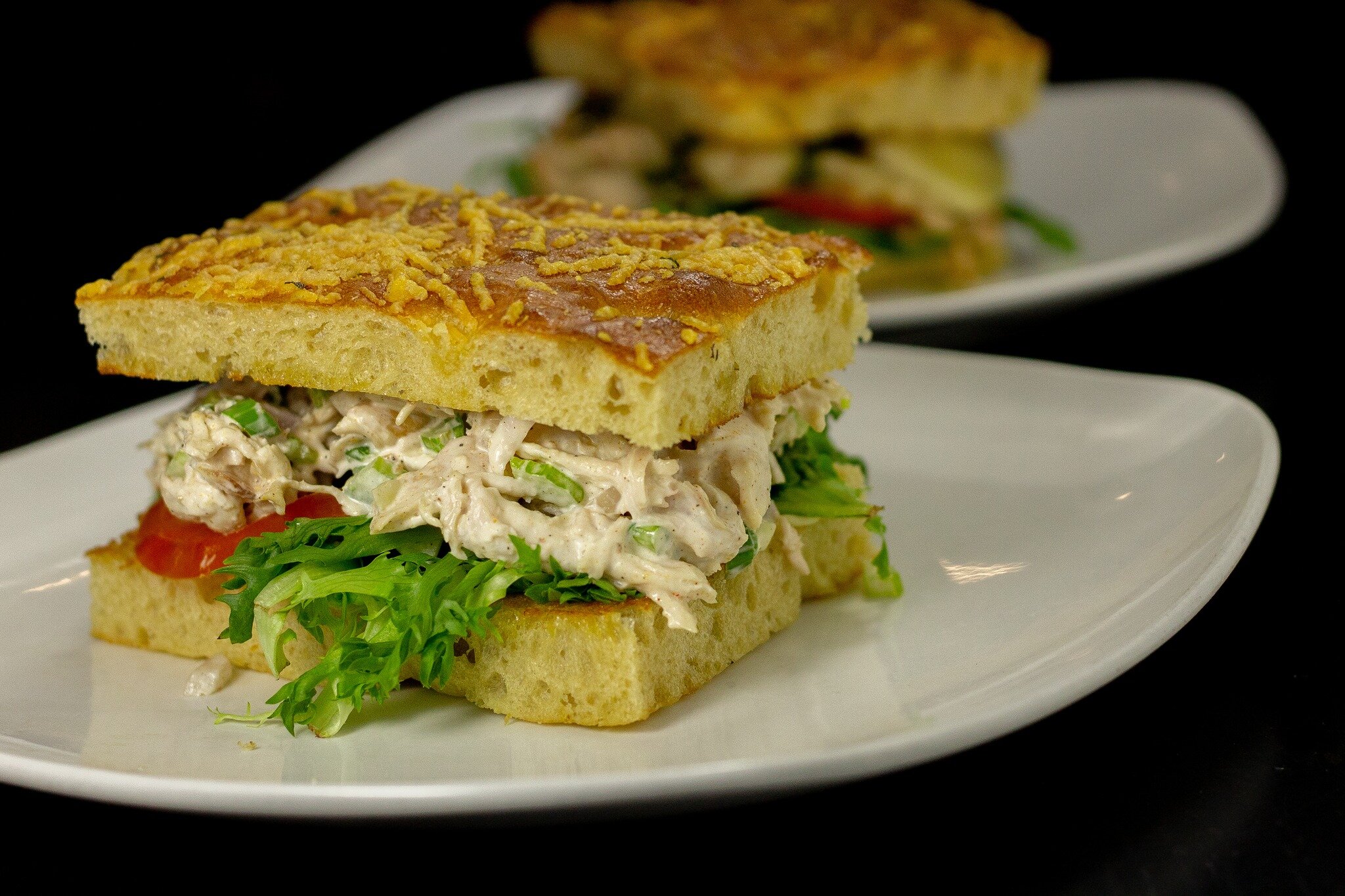 Not your average chicken salad sandwich. This recent addition to our menu features house-smoked, shredded chicken served on house-made, toasted focaccia bread.  Served with your choice of a side for a delightful summer meal! 🥪