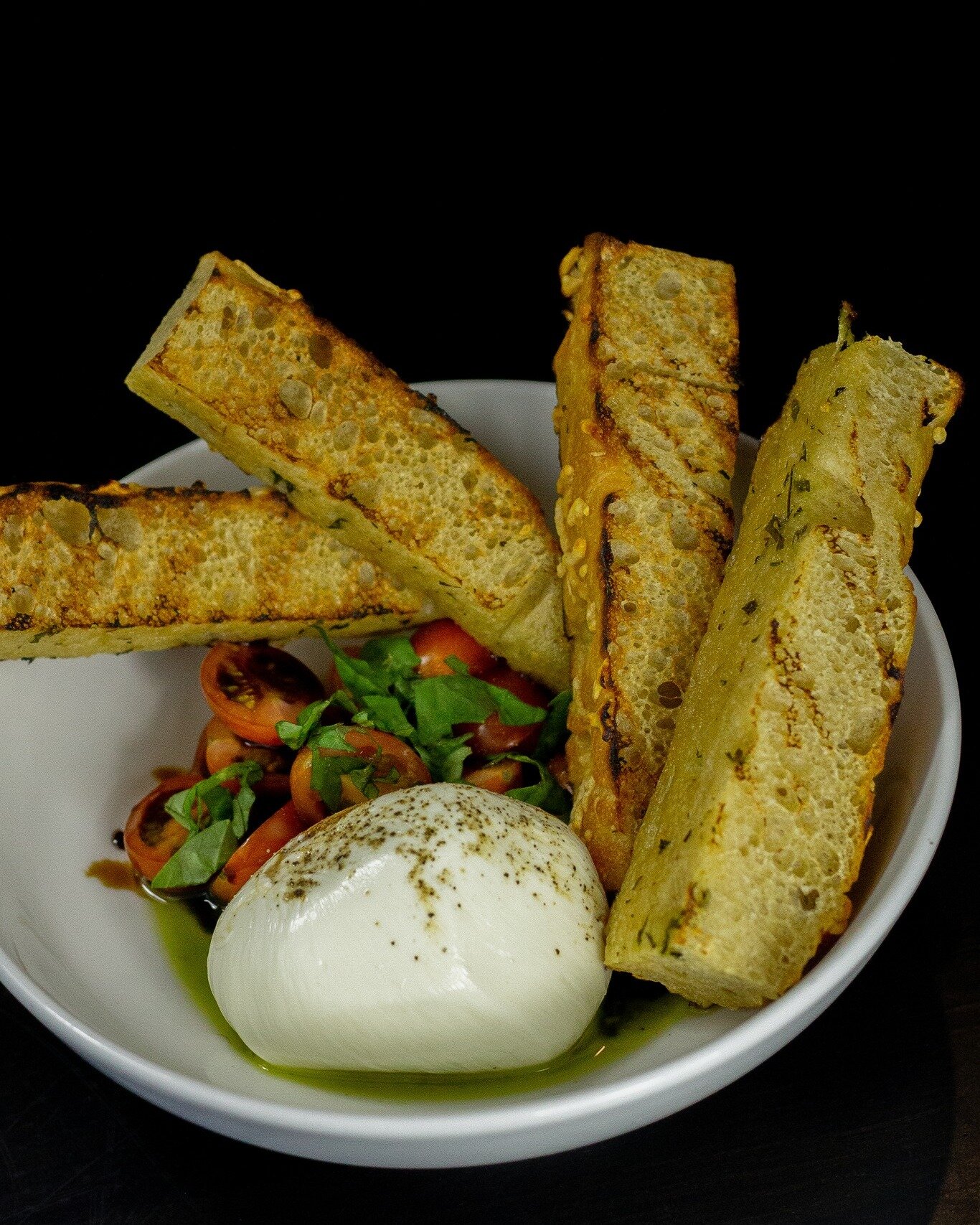 Burrata is the creamier cousin of mozzarella &ndash; firm on the outside, with a deliciously spreadable interior that pairs perfectly with tomato-basil bruschetta &amp; our house-made focaccia bread.