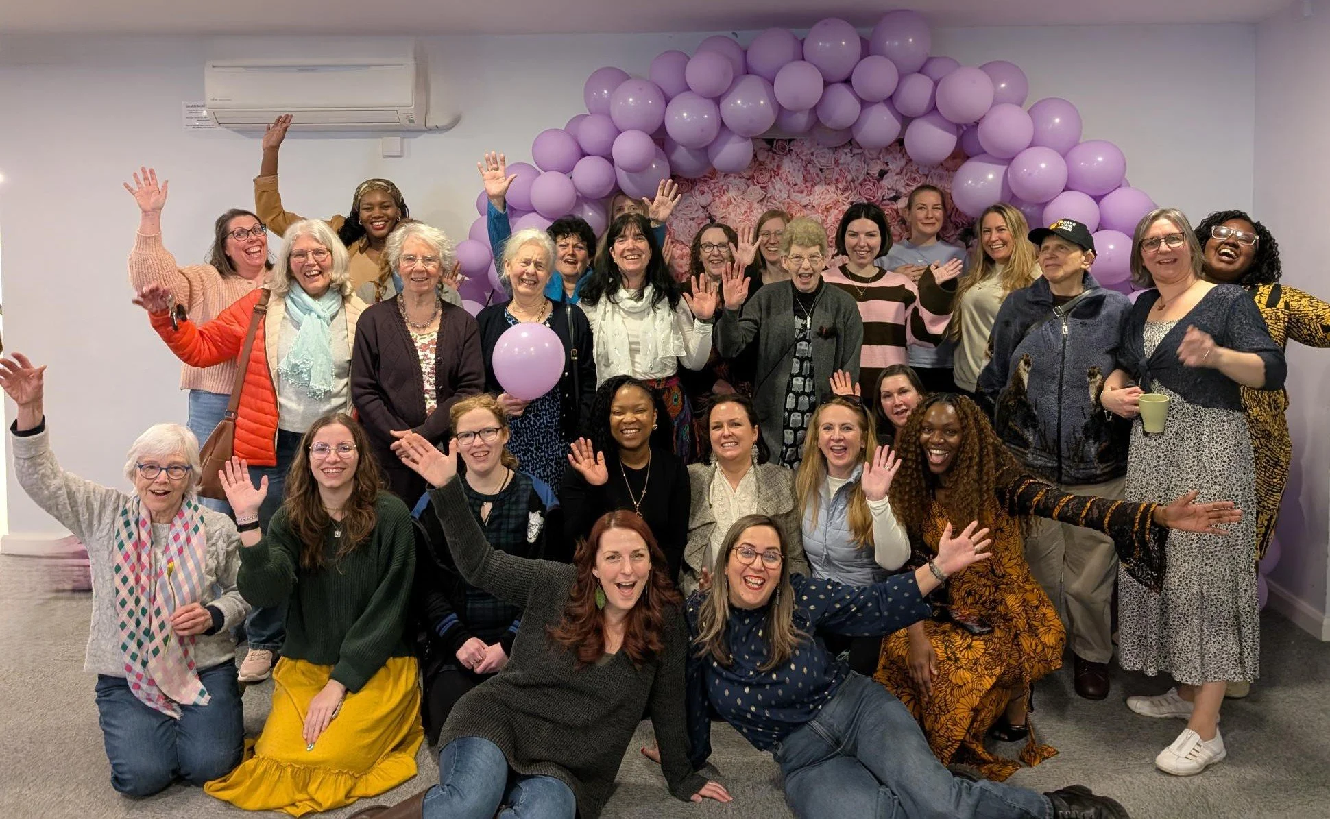 lots of women posing together with happy faces