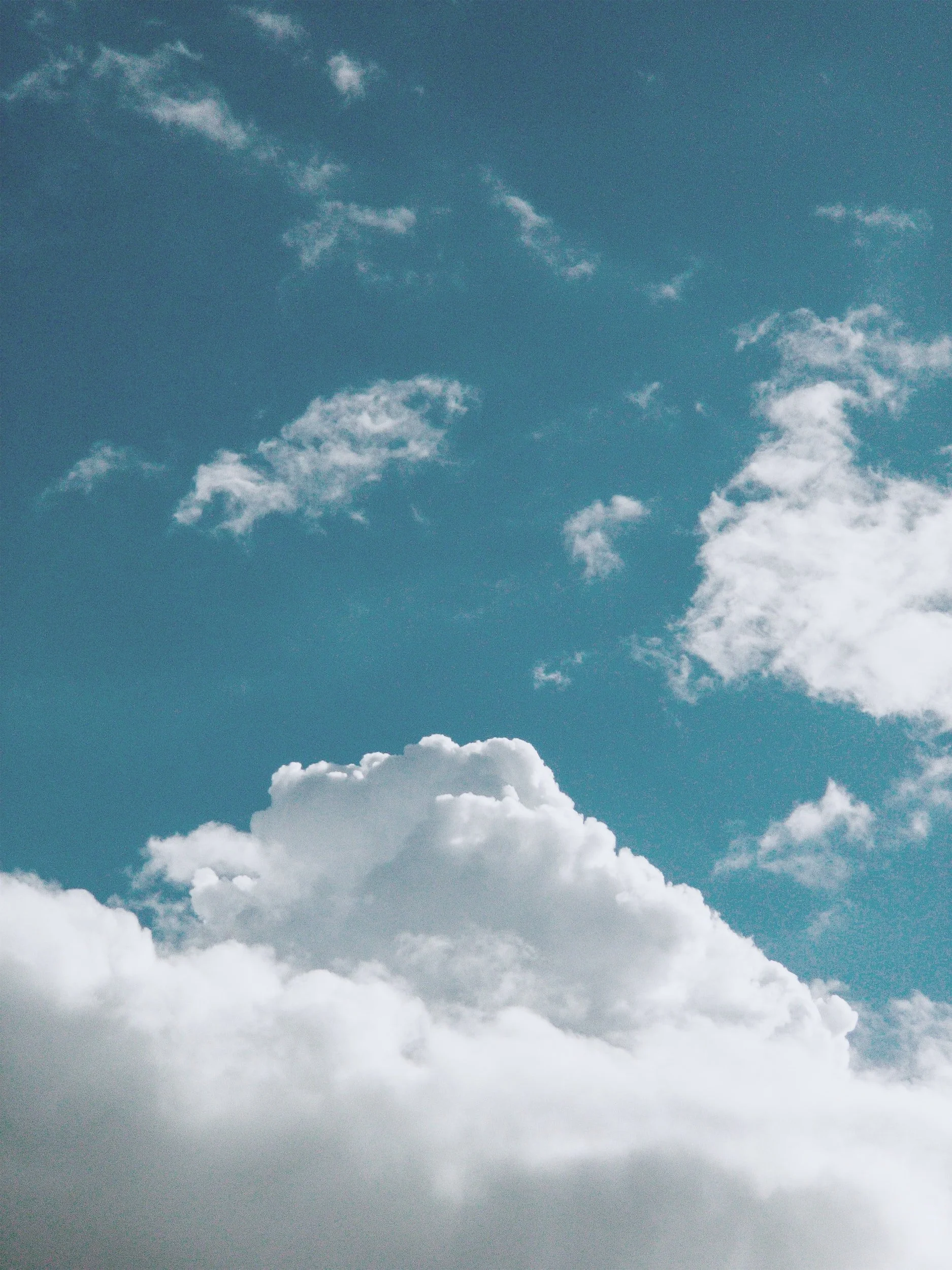 A clear blue sky with scattered white clouds.