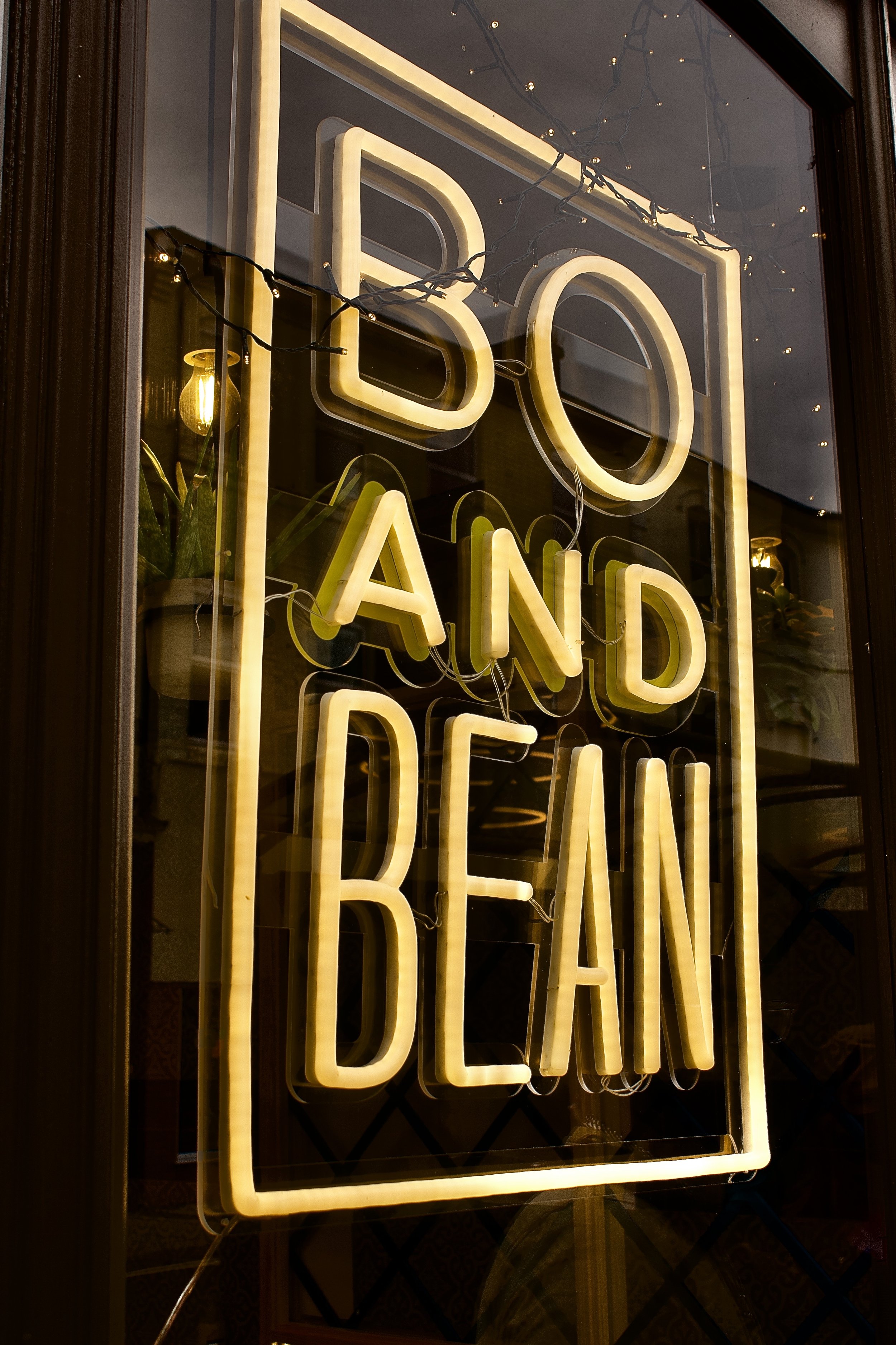 Neon sign saying "BO AND BEAN" in a window.