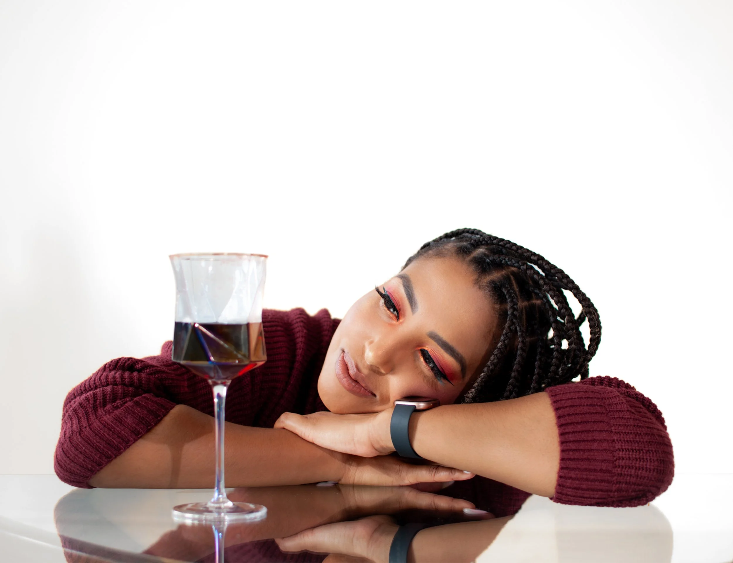 Smiling young woman making a heart shape with her hands.