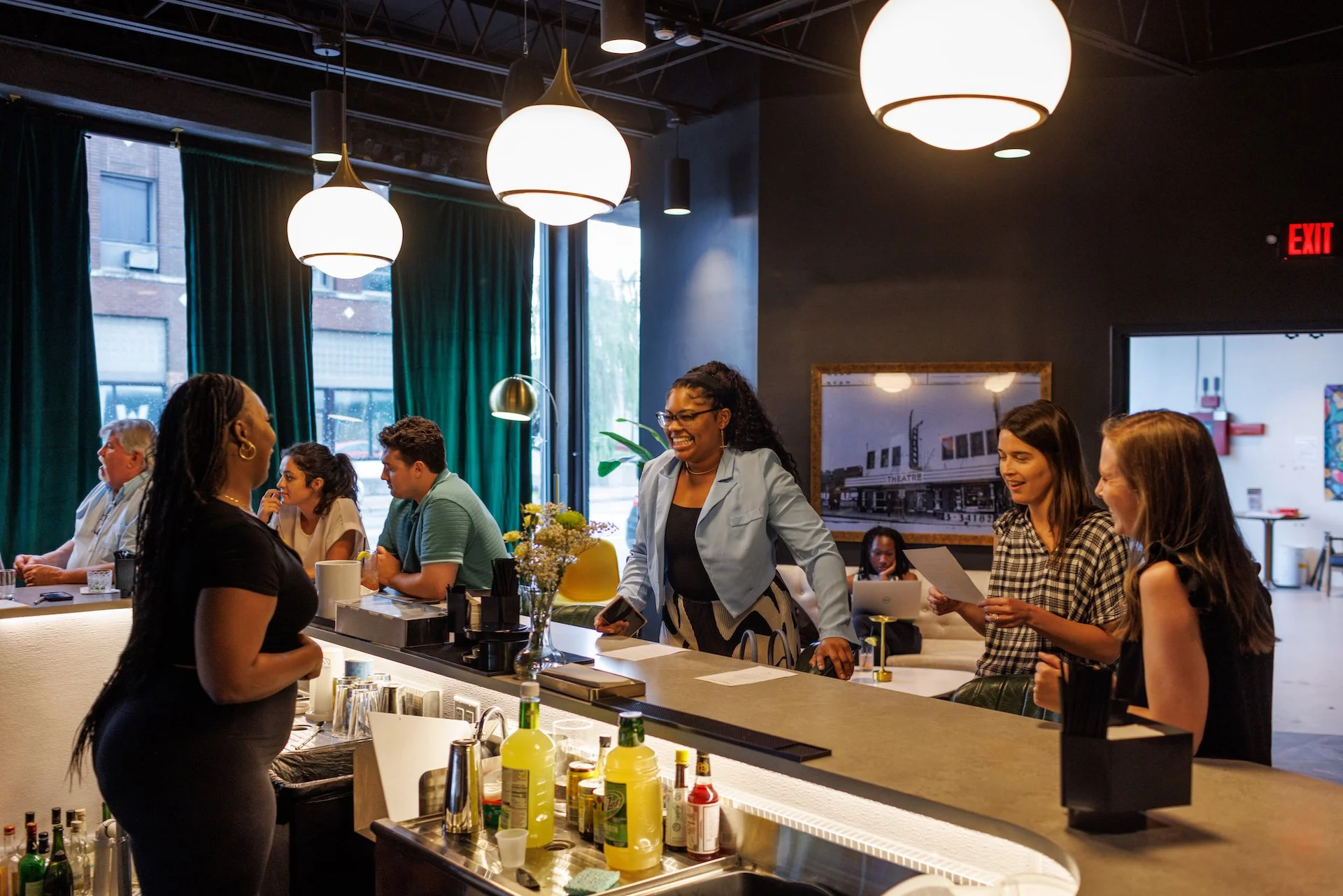A private event at Woodlawn Theatre with bar service and smiling faces.