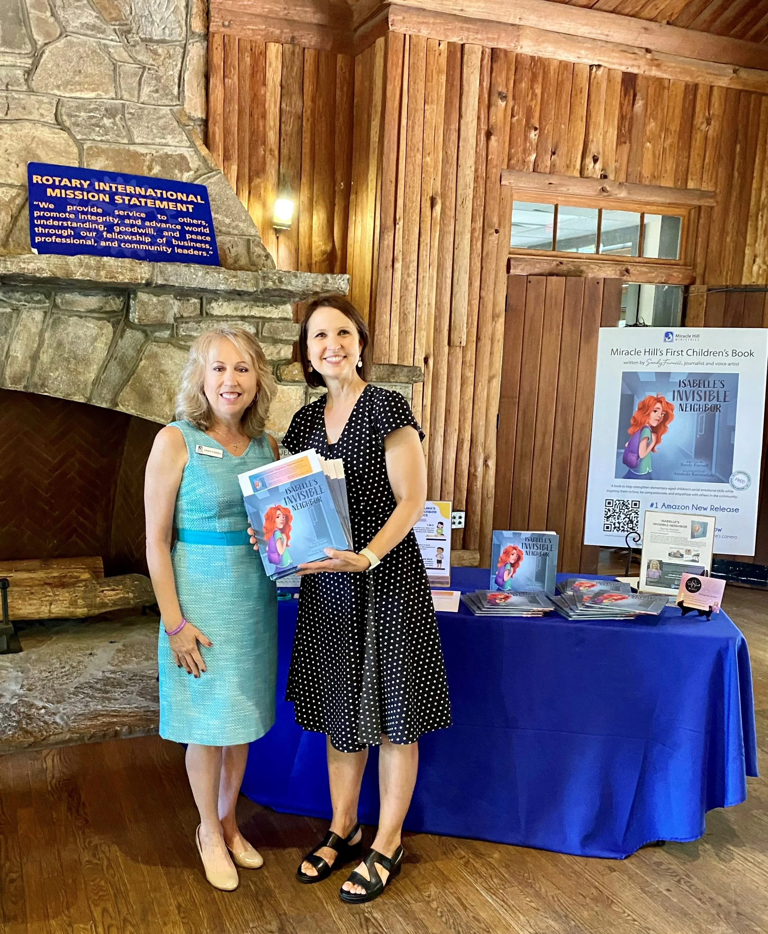 Sandy Furnell presenting copies of Isabelle's Invisible Neighbor to Habersham County Schools representative