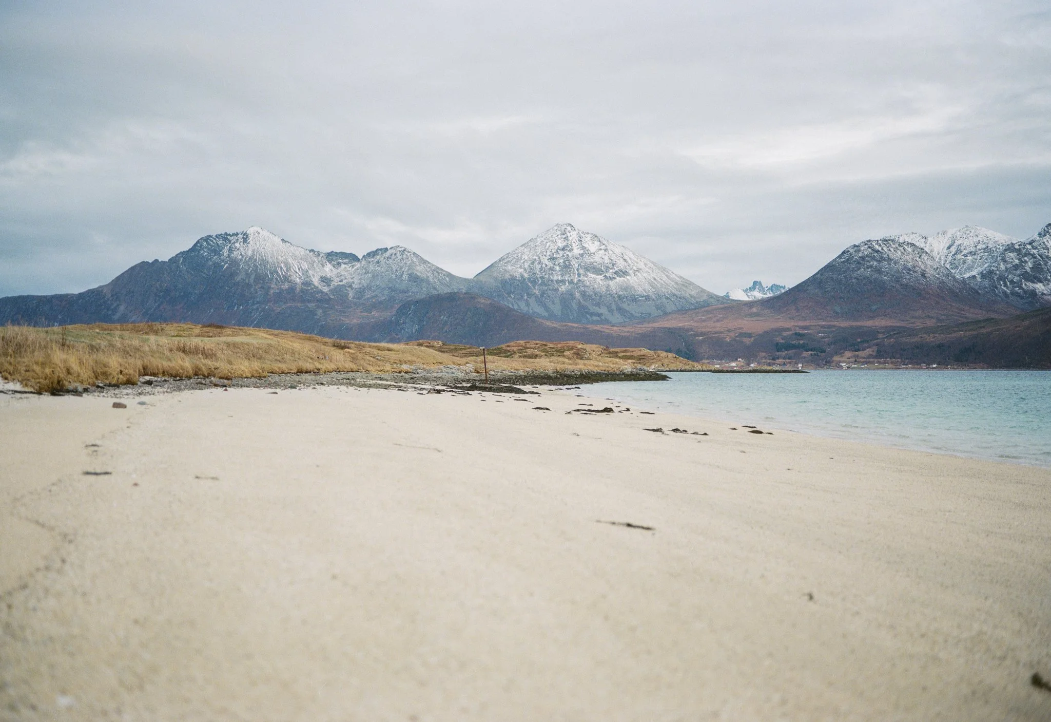 Small Beach Overlooked by Distant Mountains