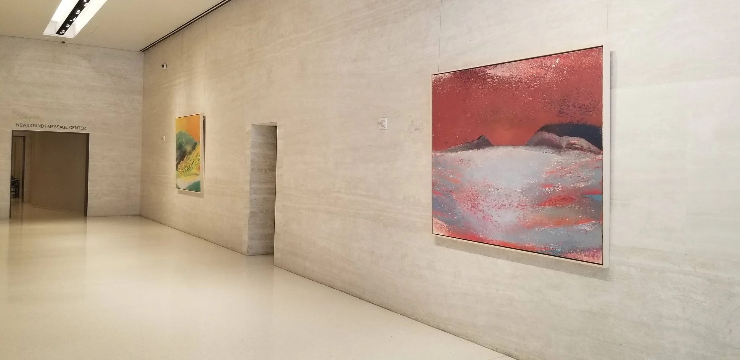 Original large-scale landscape paintings for sale in red and orange tones, displayed in a corporate lobby — view available paintings