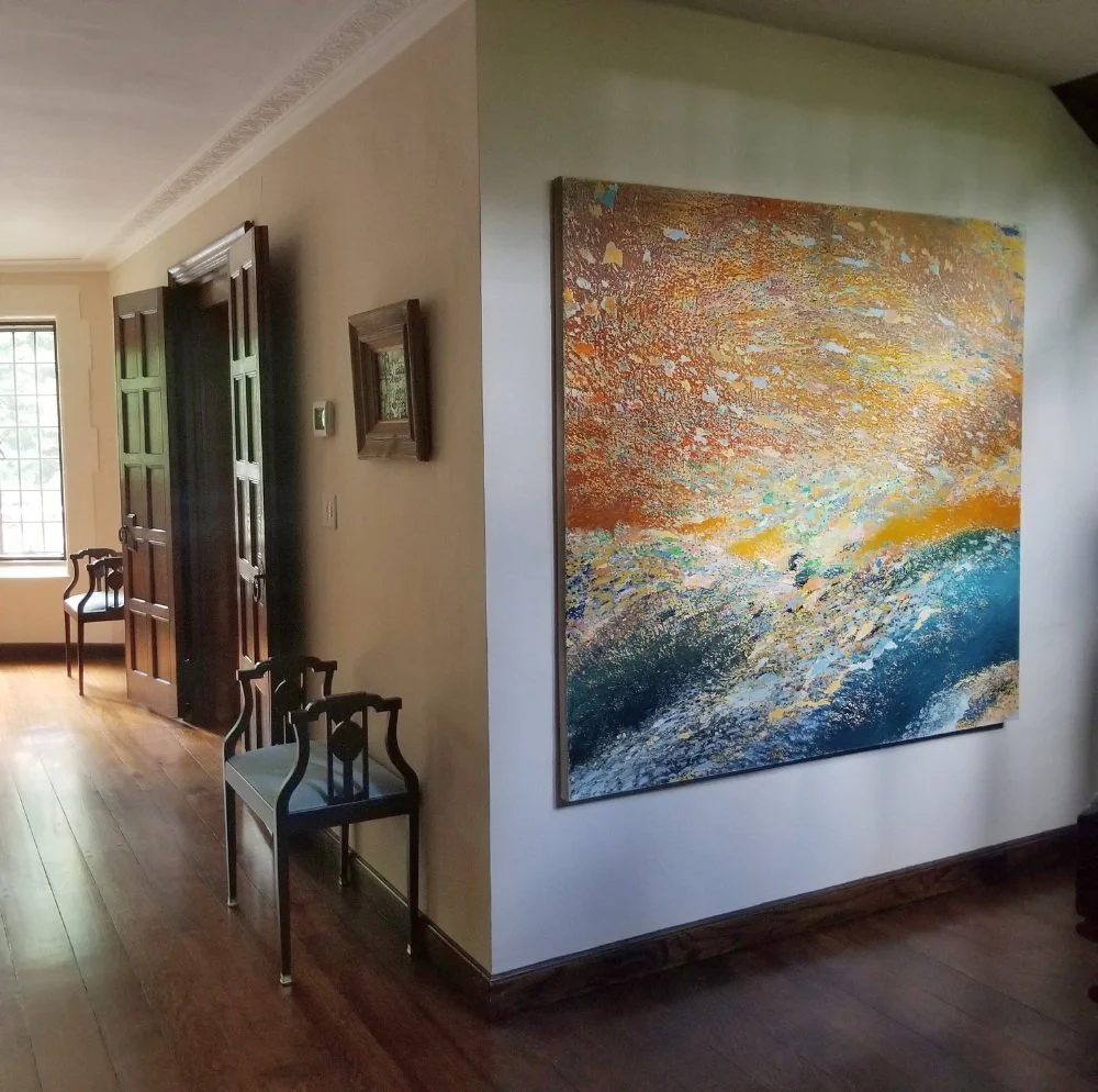 Original large landscape painting for sale installed in a residential living room.