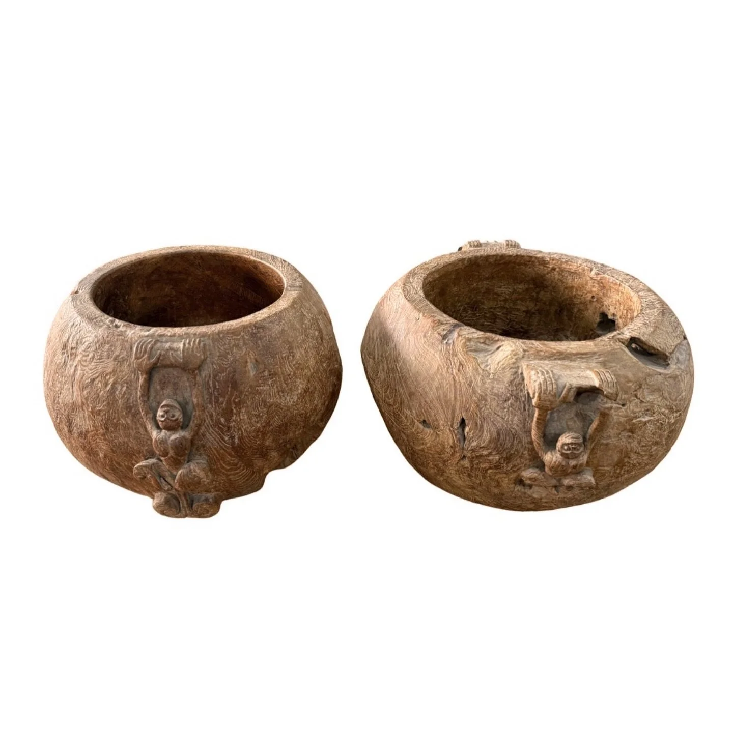 This striking set of hand-carved teak bowls is crafted from solid blocks of burl wood, a material highly prized for its rarity and dramatic natural patterning. Burl wood forms when a tree undergoes an unusual growth&mdash;often at the base&mdash;resu