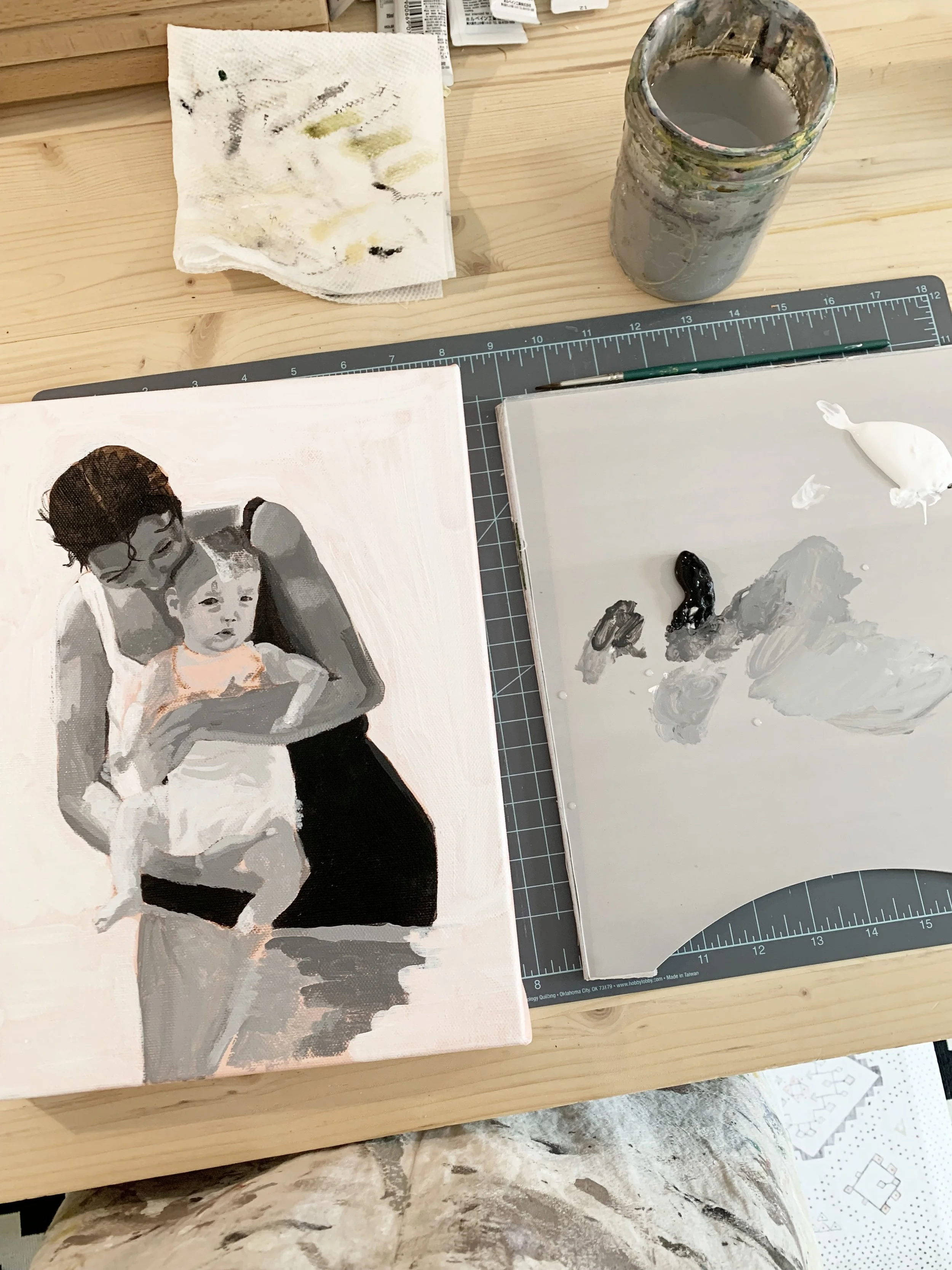 unfinished painting in black and white of mother and child playing in the water