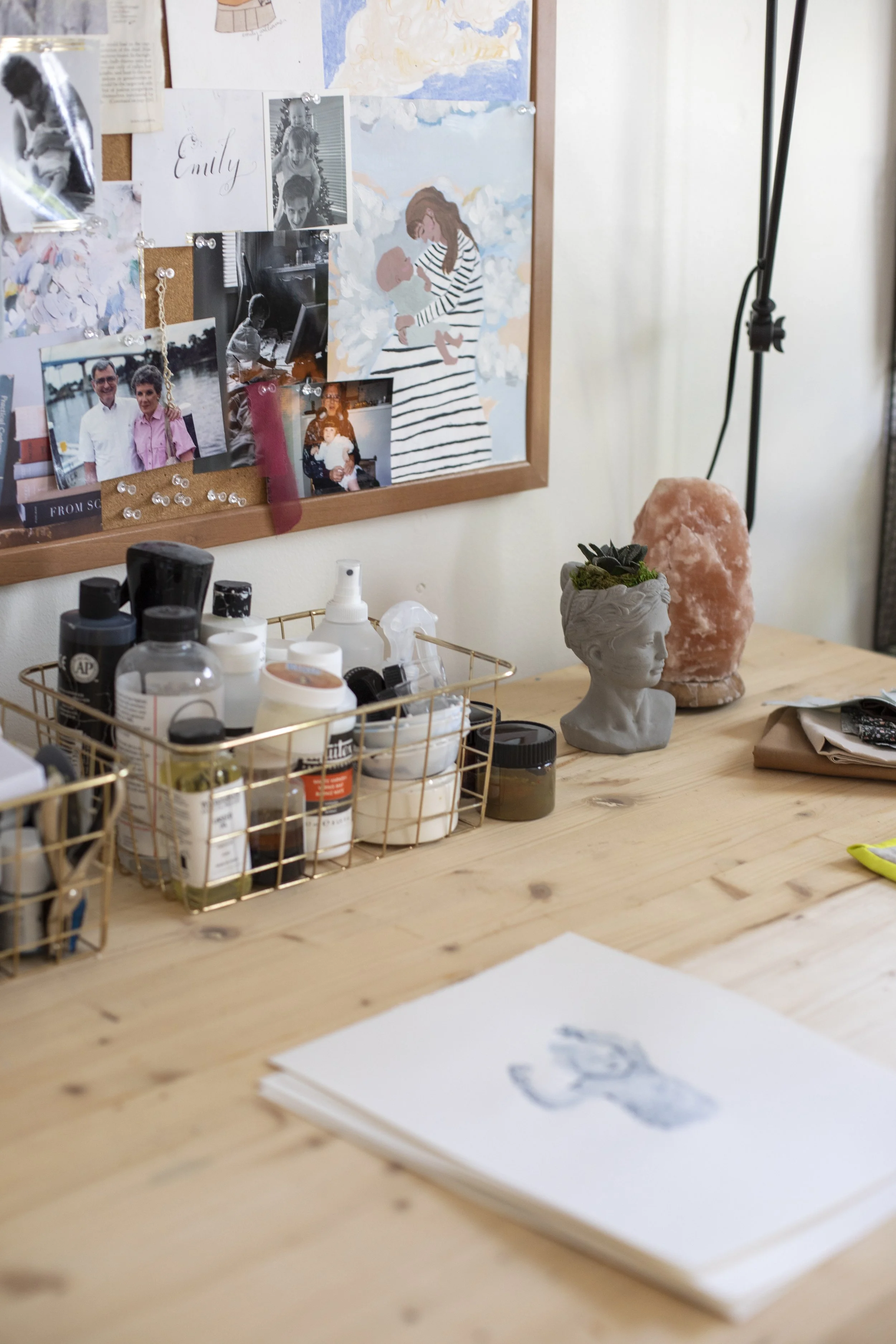 A studio table and painting materials sitting on it