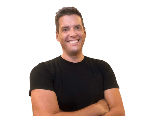 James Palmer CMT, A man with short dark hair, wearing a black t-shirt, smiling and standing with his arms crossed against a plain background.