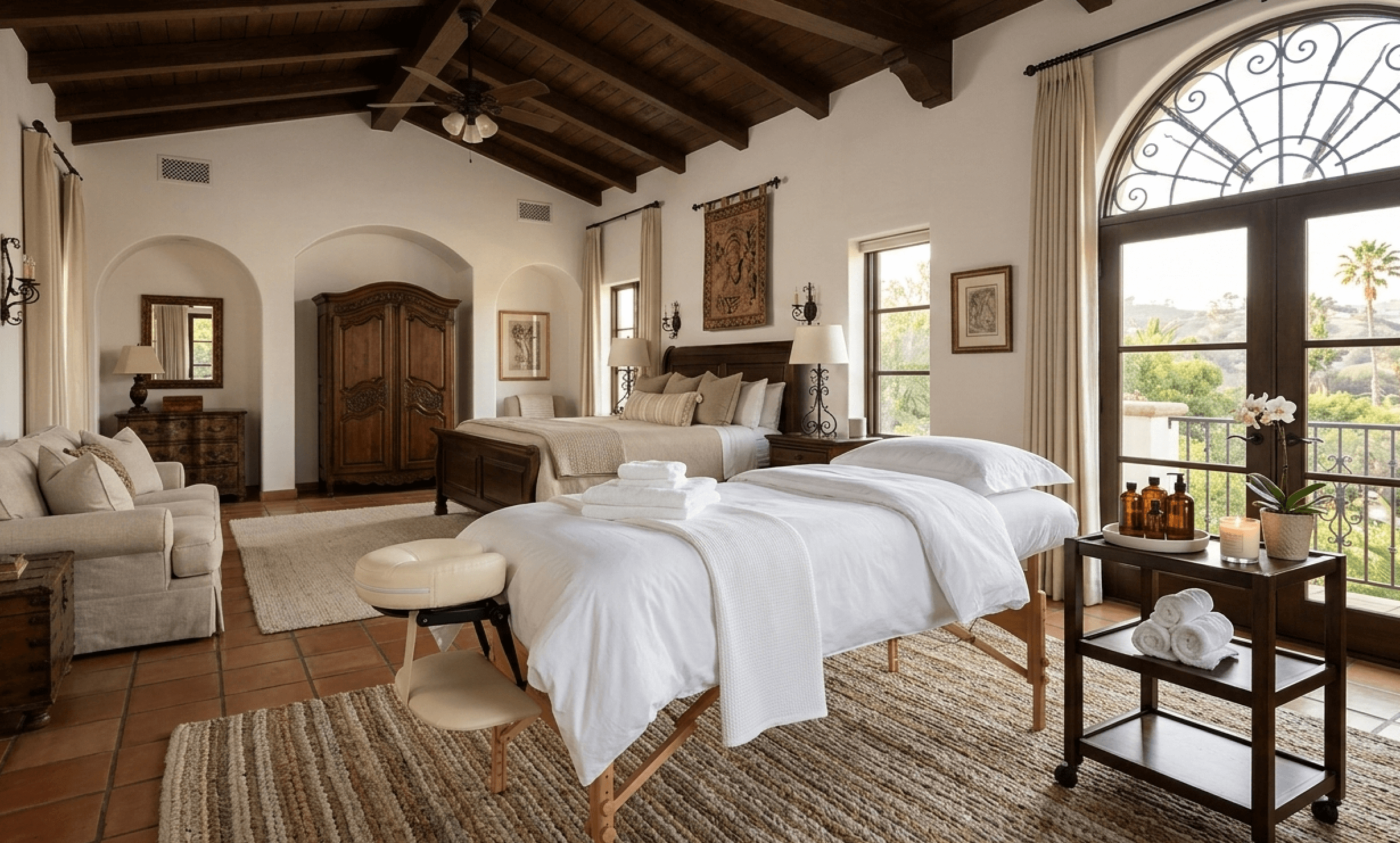 A massage table is set up in a spanish style bedroom of a Beverly Hills Home