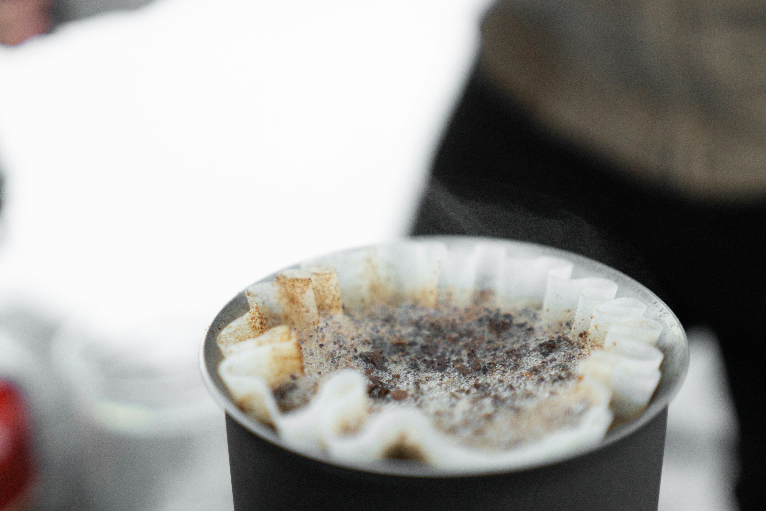 Close-up of coffee brewing in a paper filter with a pour-over method.