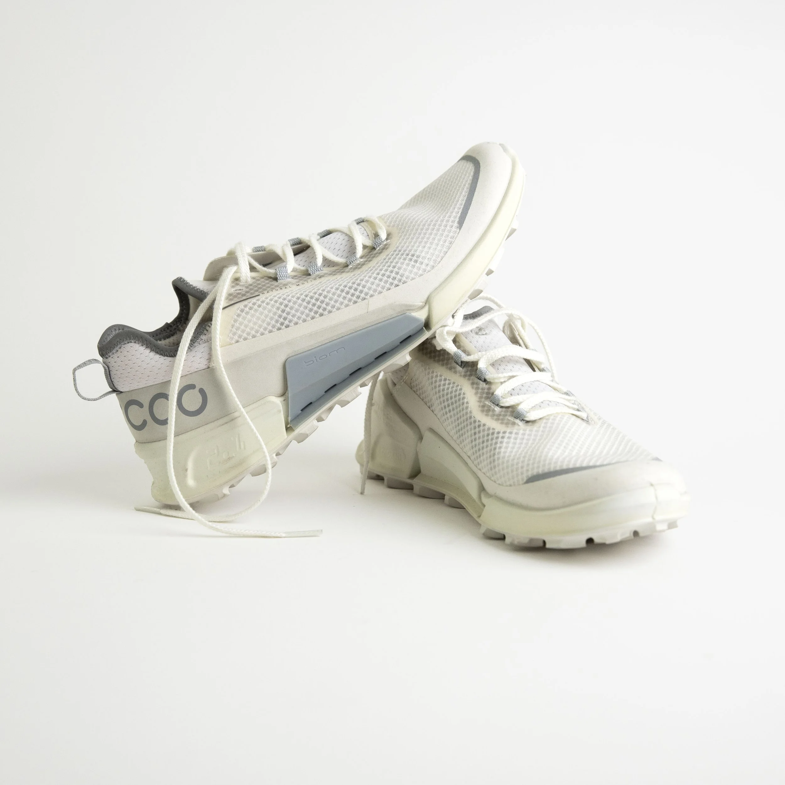 White Athletic Sneakers With Gray And Blue Detailing