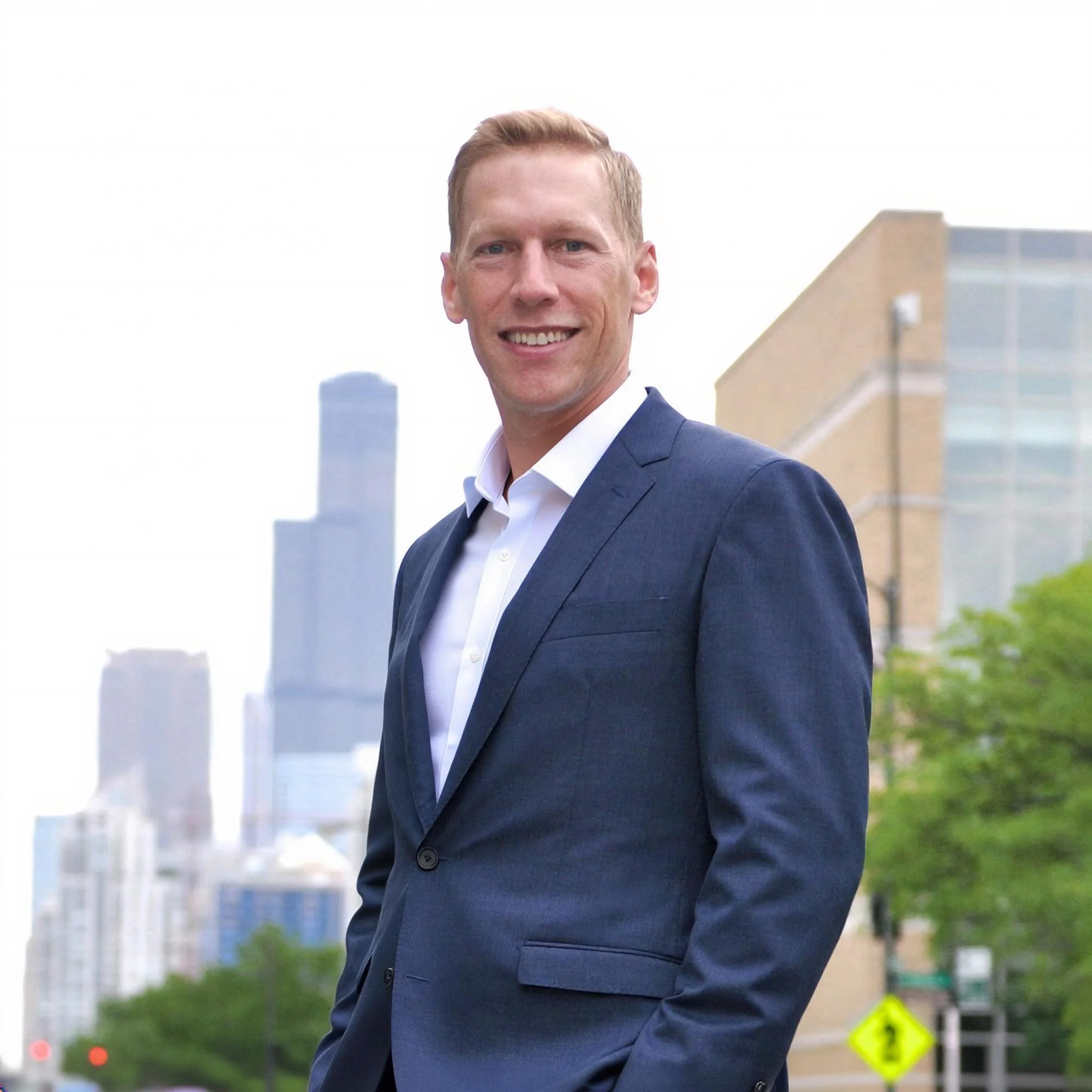 Brent Hall, local Chicago cash home buyer and property investor, standing outdoors in front of the city skyline
