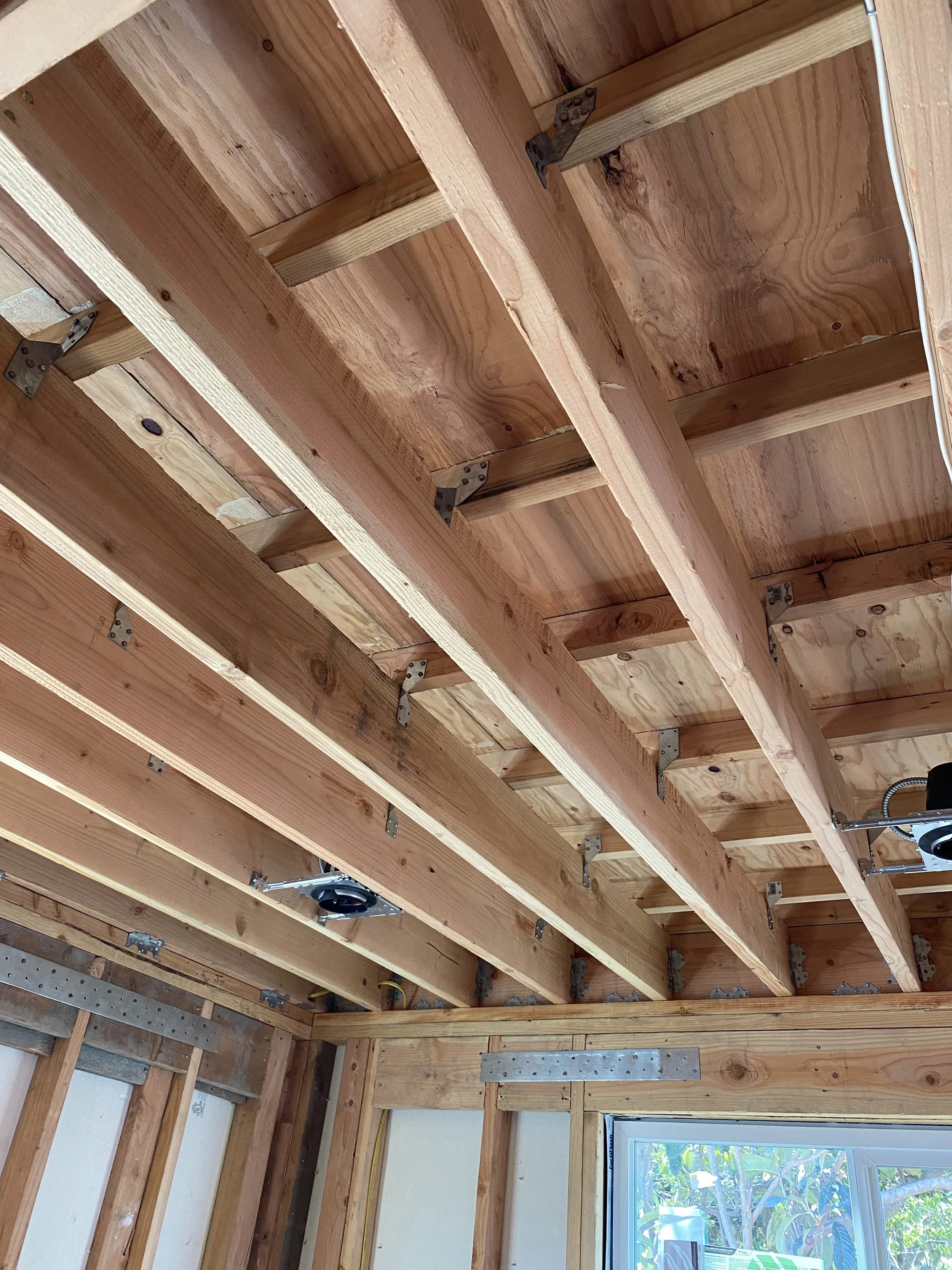Construction framing in progress with exposed studs and structural layout — San Francisco Bay Area general contractor
