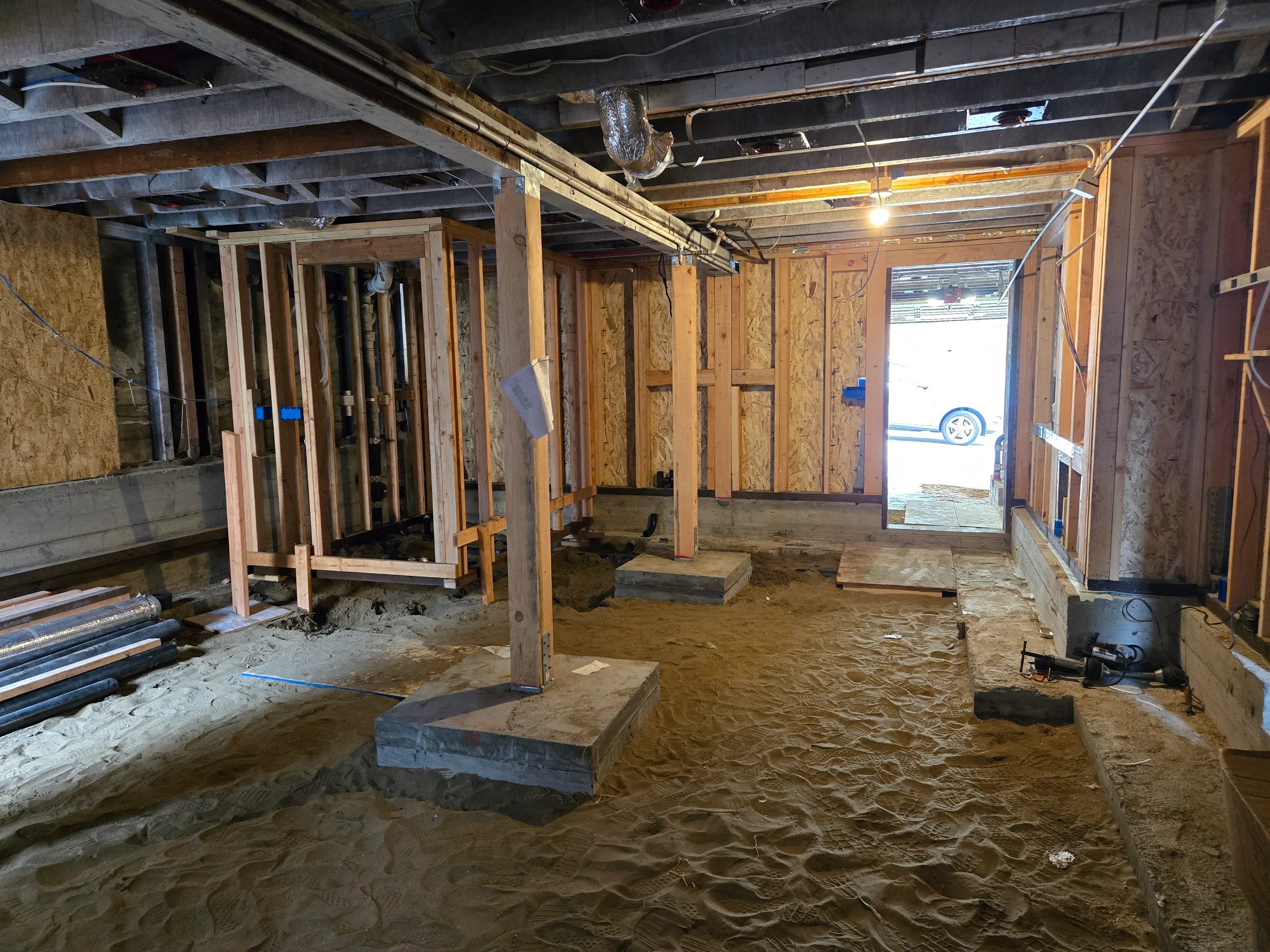 Open underfloor work zone with supports and new framing during conversion — San Francisco Bay Area general contractor