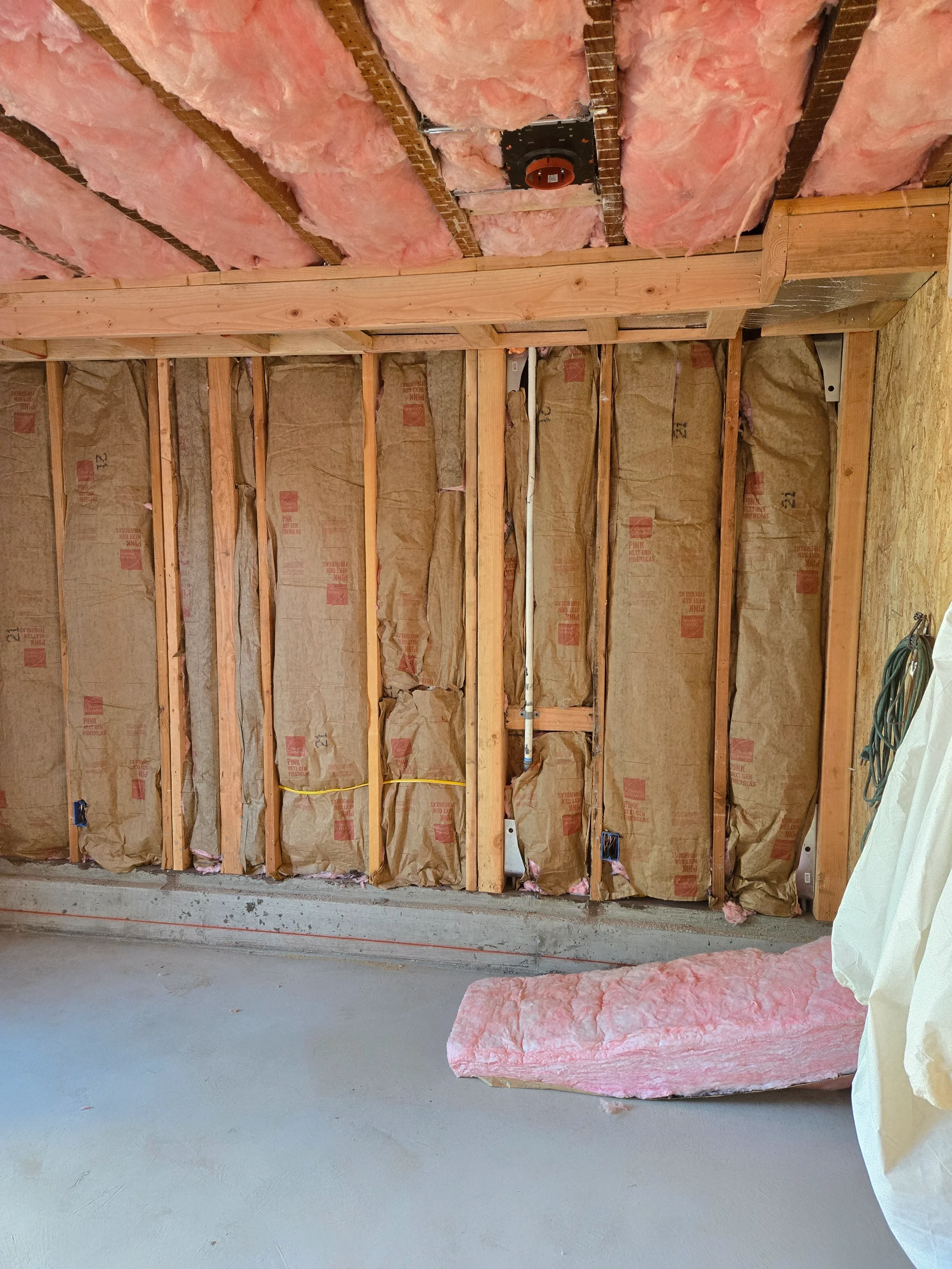 Ground-floor exterior wall framing before drywall during conversion in progress — San Francisco Bay Area general contractor