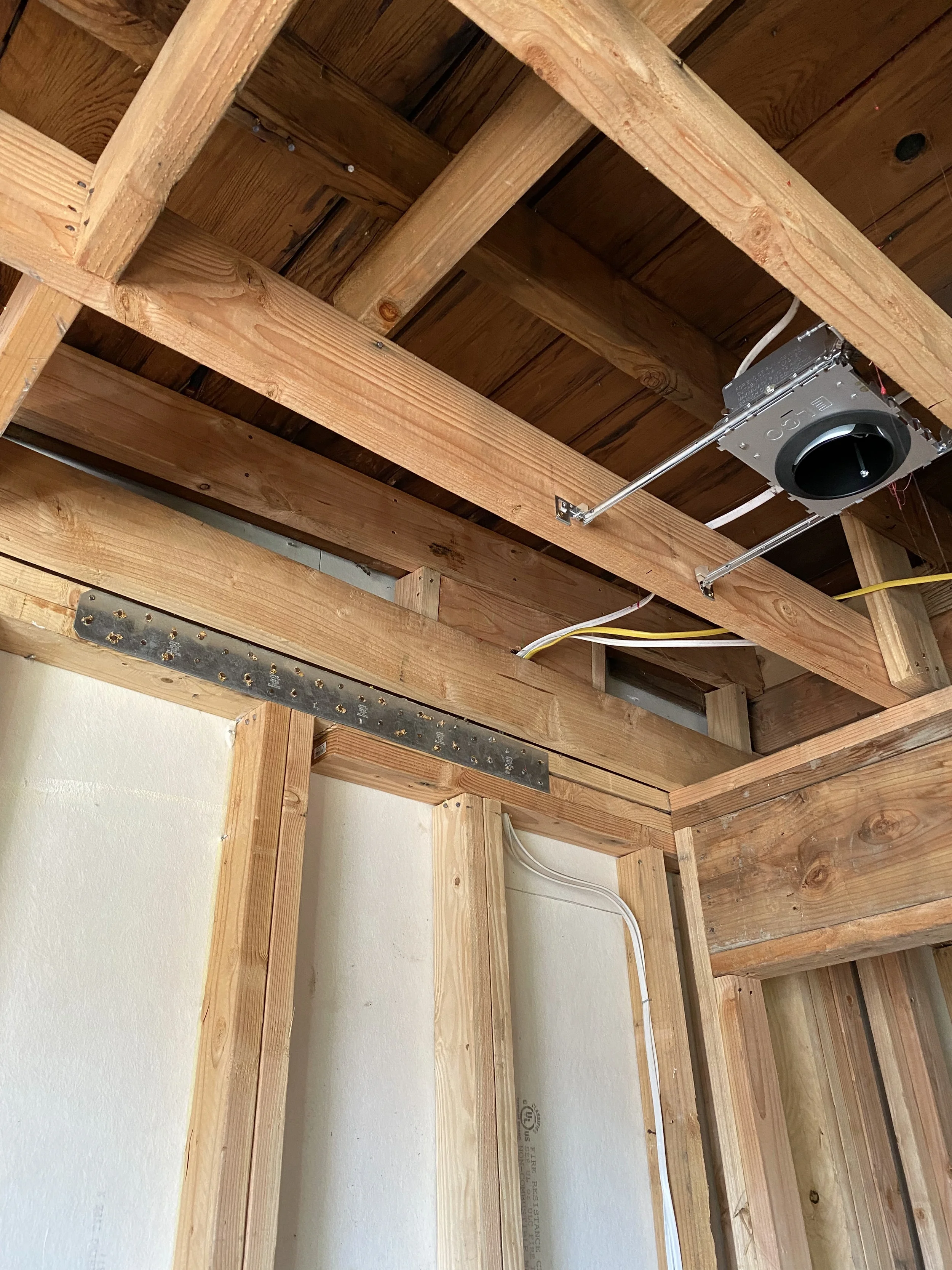 Underfloor framing detail in two-story detached ADU with exposed joists and blocking — San Francisco Bay Area general contractor