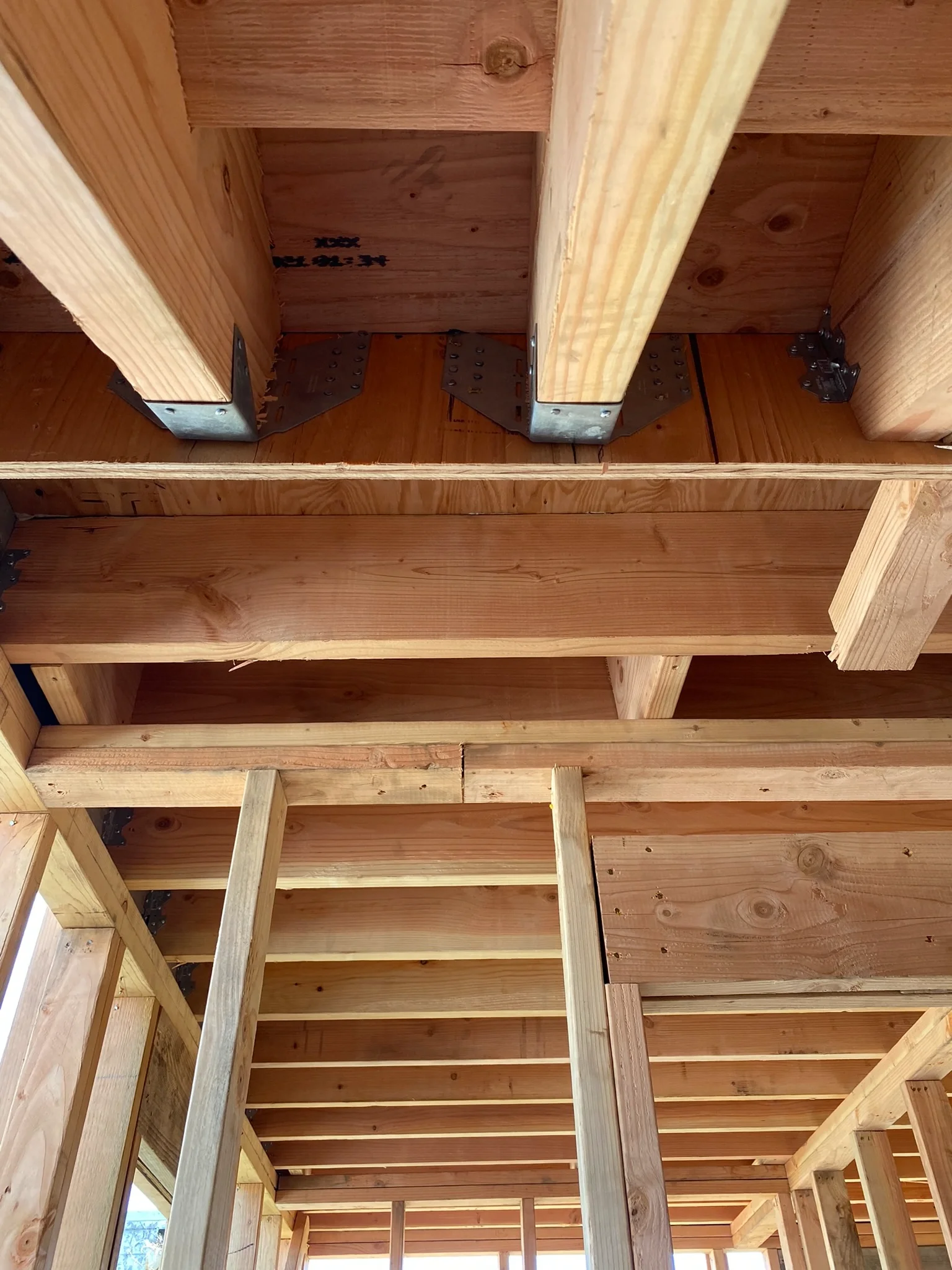 Two-story detached ADU roof framing with exposed beams and stair opening — San Francisco Bay Area general contractor