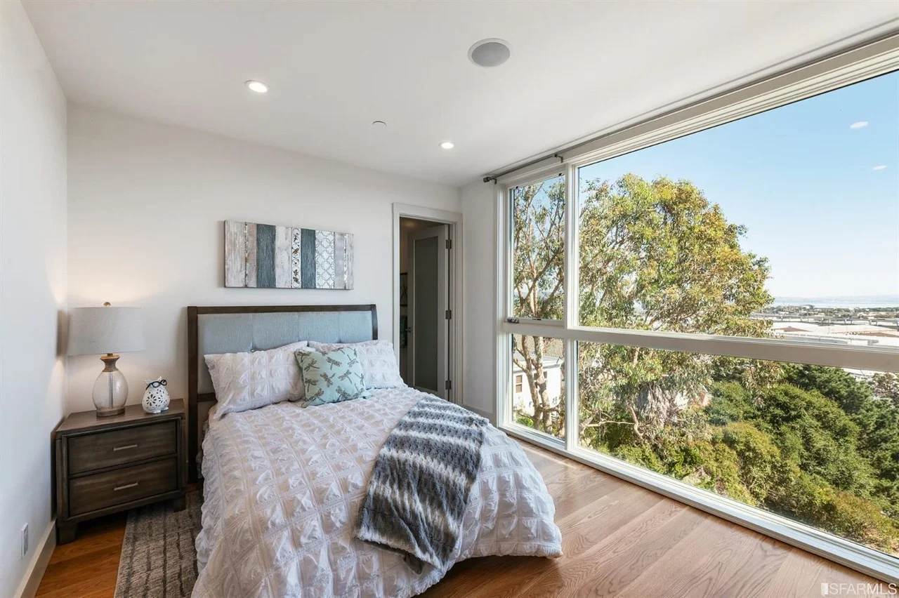 Bedroom addition with large windows and tree view — San Francisco Bay Area general contractor