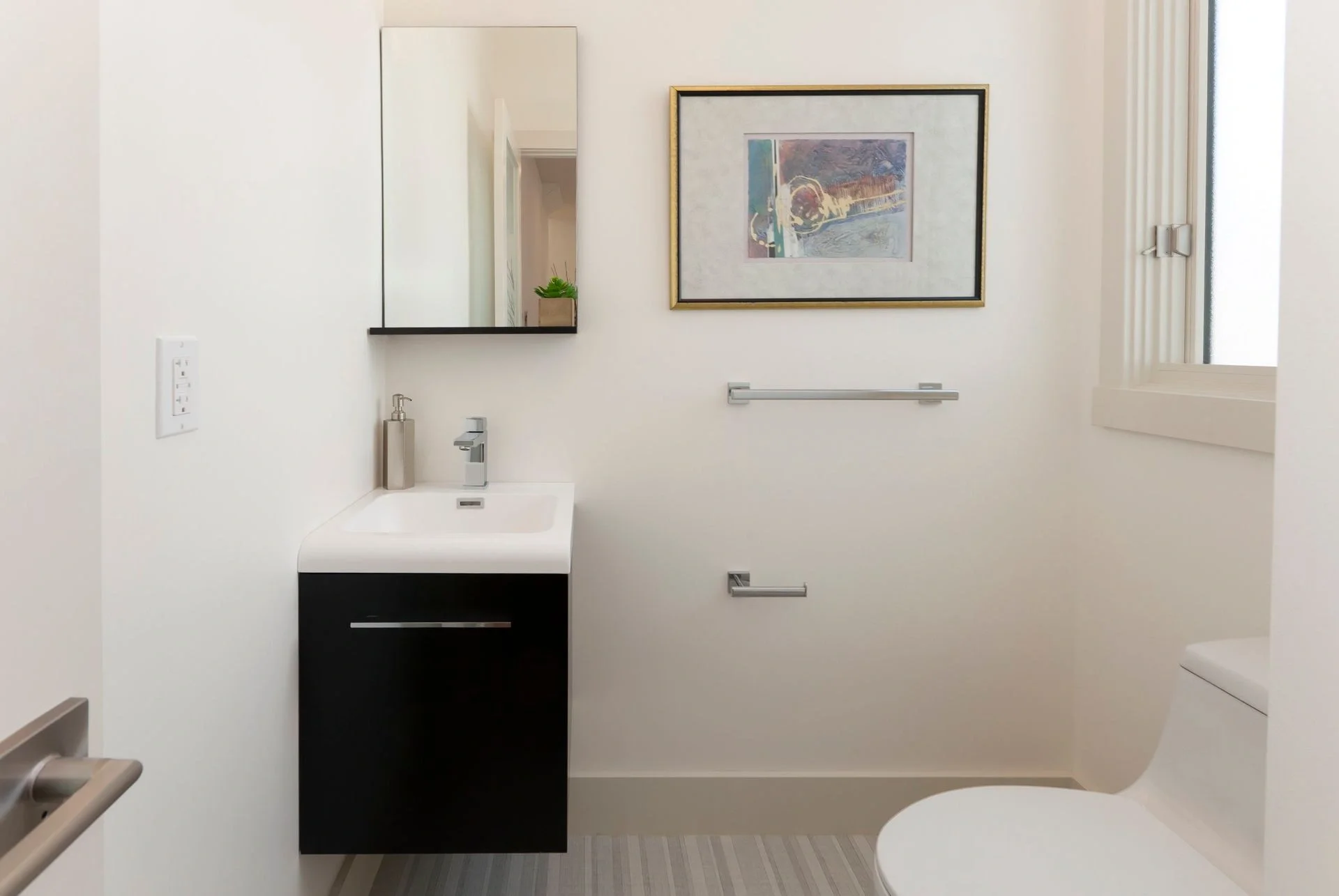 Powder room vanity in San Francisco Bay Area condominium remodel with modern sink, mirror, and clean lines — general contractor