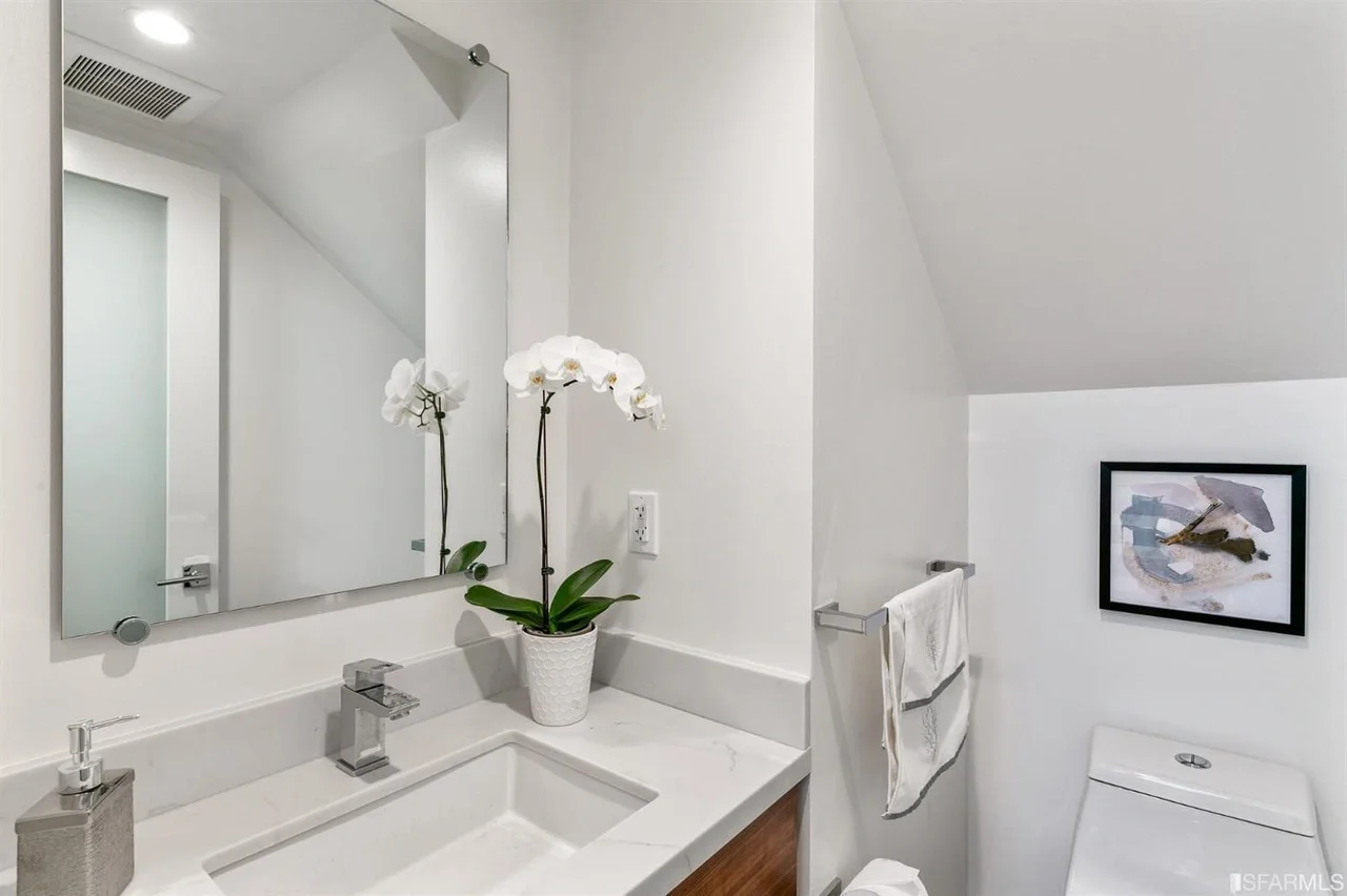 Powder room vanity in home addition with modern sink and mirror — San Francisco Bay Area general contractor