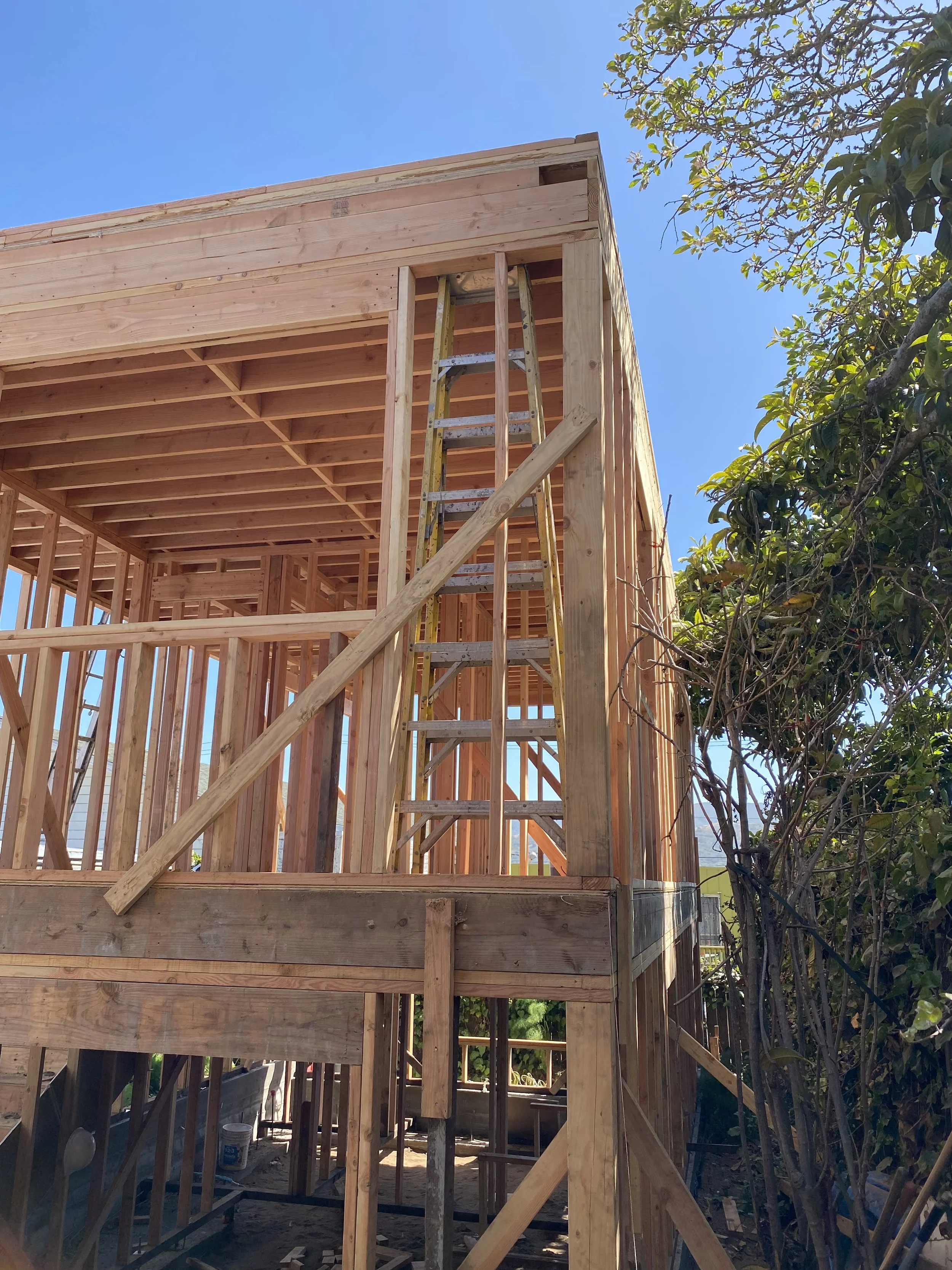 Detached ADU exterior framing with second-story deck structure and stairs — San Francisco Bay Area general contractor