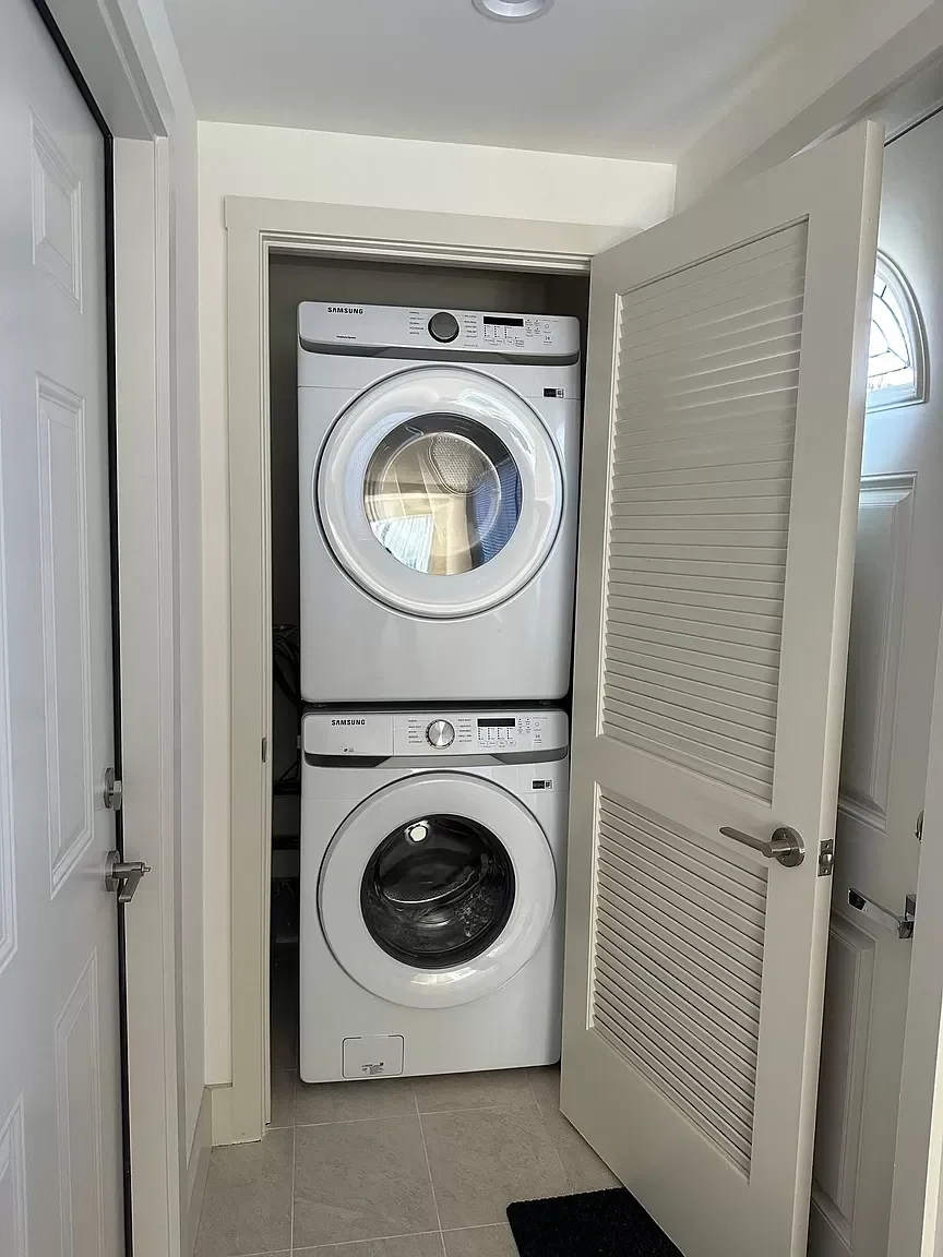 Two-story detached ADU laundry closet with stacked washer and dryer installation — San Francisco Bay Area general contractor