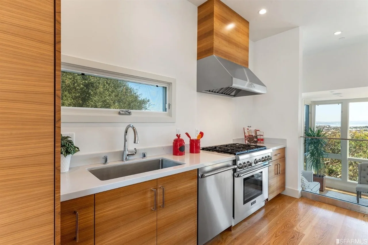 Modern kitchen addition with wood cabinets, stainless appliances, and stone counters — San Francisco Bay Area general contractor