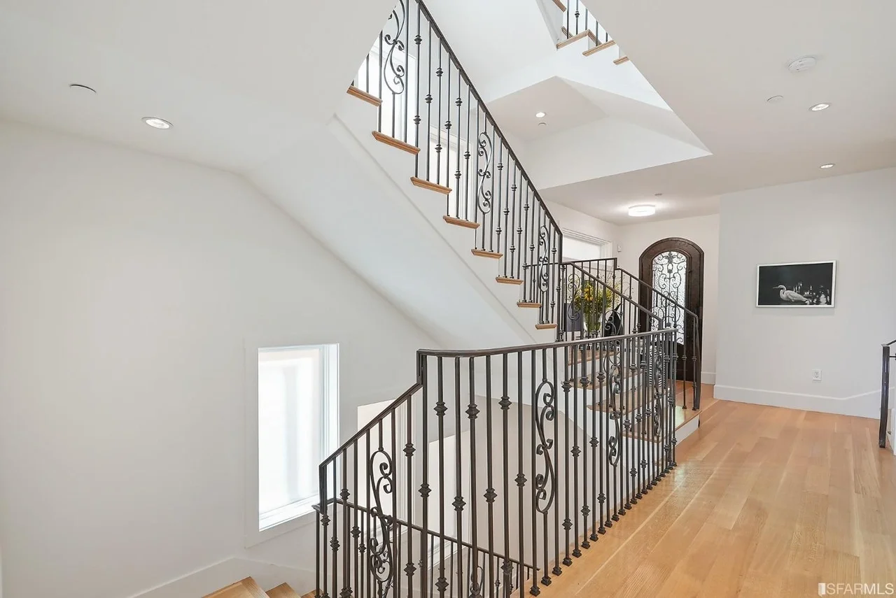 Staircase renovation with iron railing and wood treads — San Francisco Bay Area general contractor.
