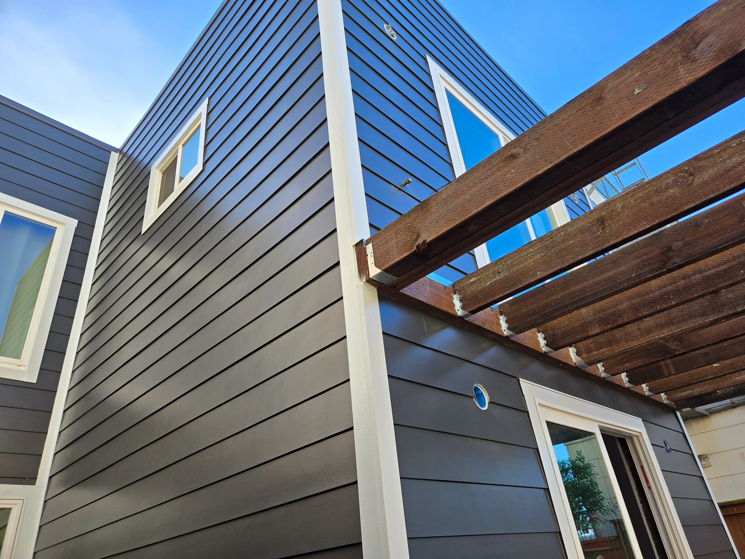 Exterior siding installation in progress for ground-floor conversion project — San Francisco Bay Area general contractor