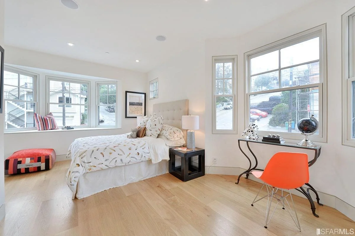 bedroom sitting area with corner windows and hardwood floors — San Francisco Bay Area general contractor