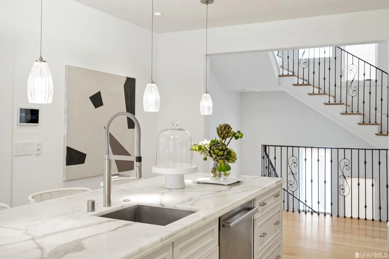 Open kitchen island renovation with pendant lights and modern finishes — San Francisco Bay Area general contractor.