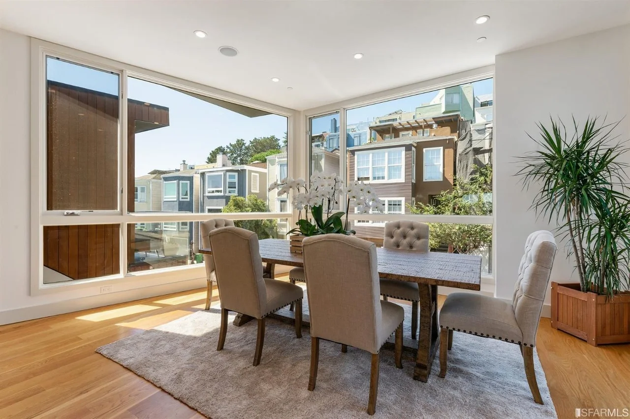 Dining table next to kitchen in home addition with hardwood floors and recessed lighting — San Francisco Bay Area general contractor