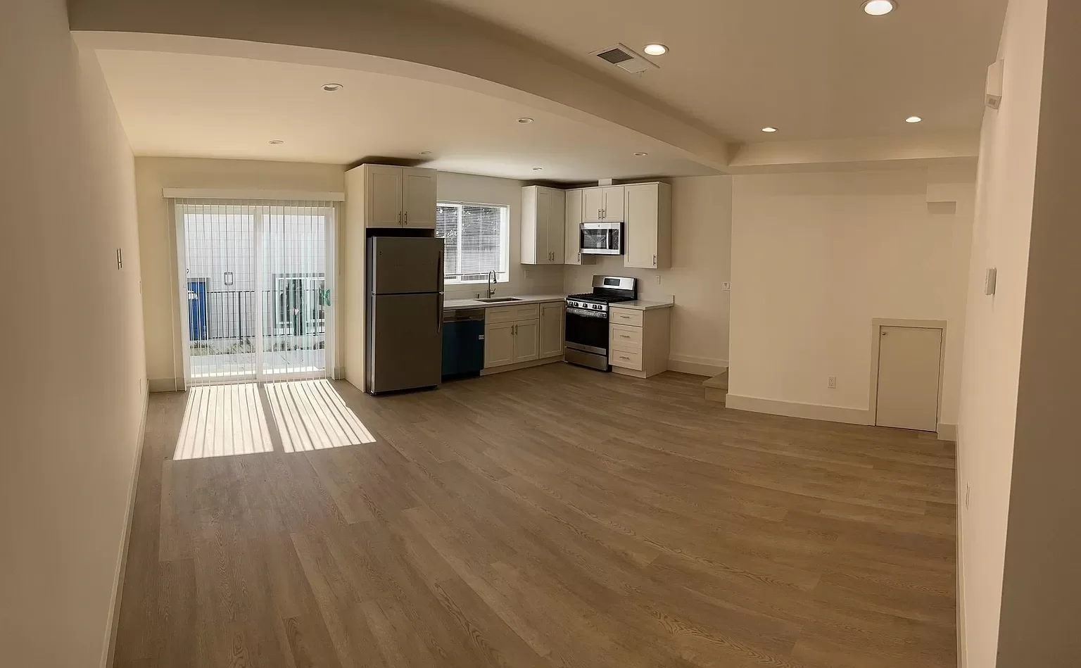 Two-story detached ADU open kitchen and living area with modern cabinetry and peninsula — San Francisco Bay Area general contractor