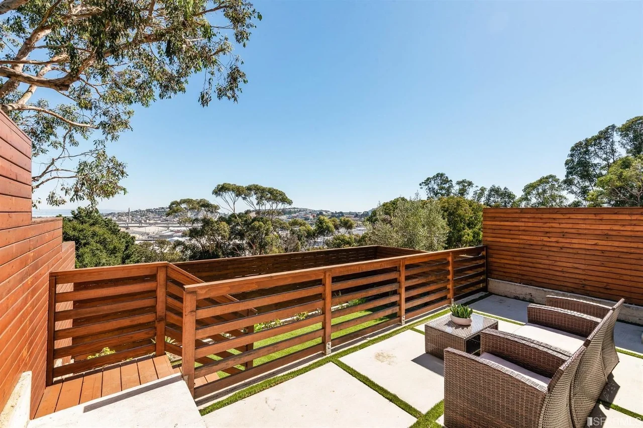Private outdoor deck with wood railing and treetop view — home addition — San Francisco Bay Area general contractor