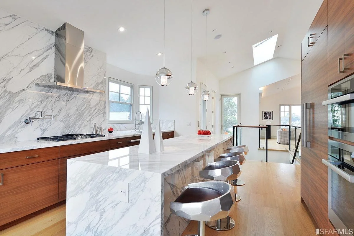 Open kitchen with large island, pendant lighting, and bar seating — San Francisco Bay Area general contractor