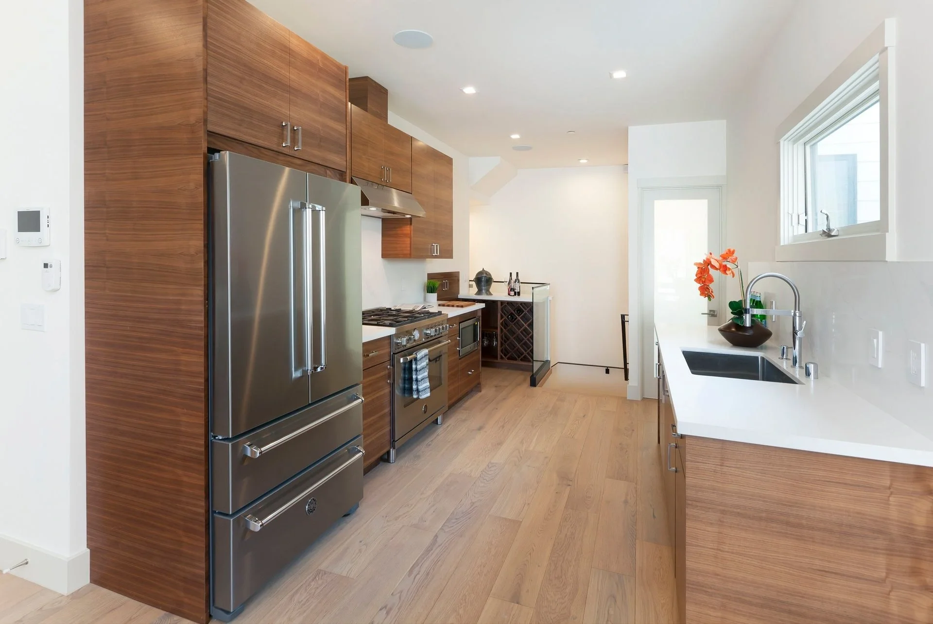 Kitchen renovation showing stainless refrigerator and custom wood cabinets — San Francisco Bay Area general contractor