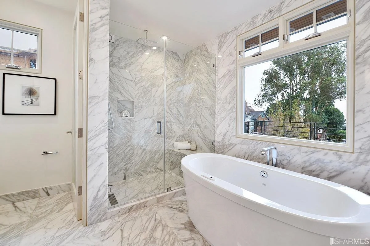 primary bathroom with freestanding tub and marble tile walls — San Francisco Bay Area general contractor
