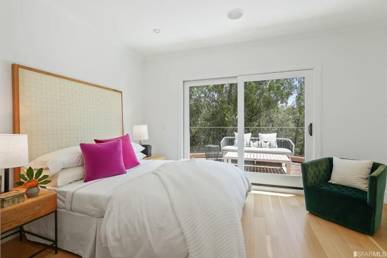 Bright bedroom renovation with hardwood floors and balcony doors — San Francisco Bay Area general contractor.