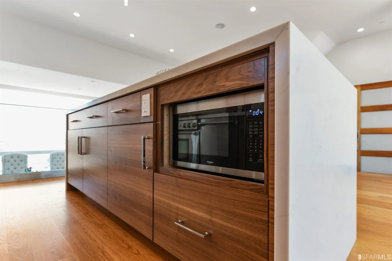 Custom built-in media wall with wood paneling in home addition — San Francisco Bay Area general contractor