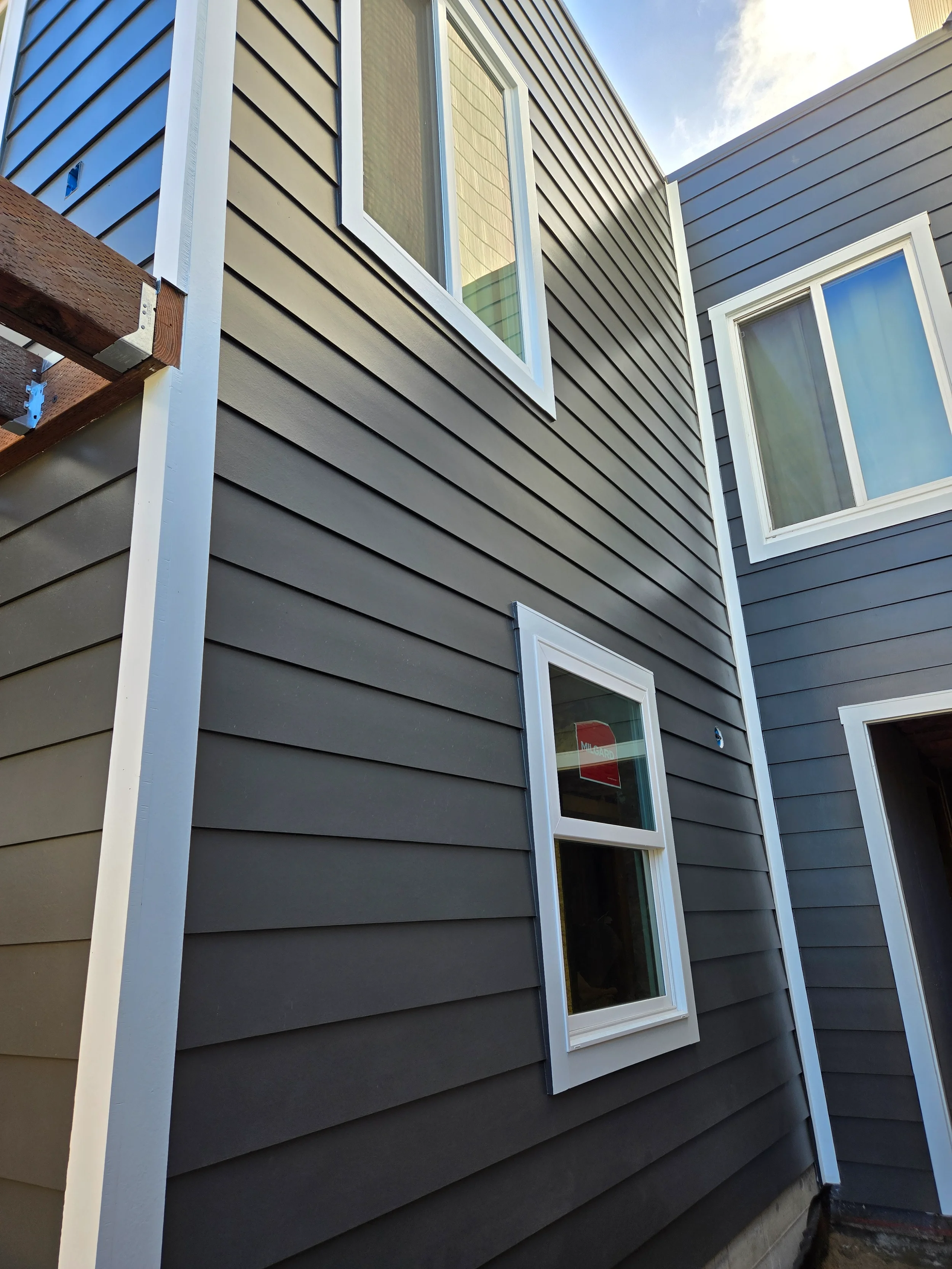 Exterior siding and window detail during ground-floor conversion construction — San Francisco Bay Area general contractor