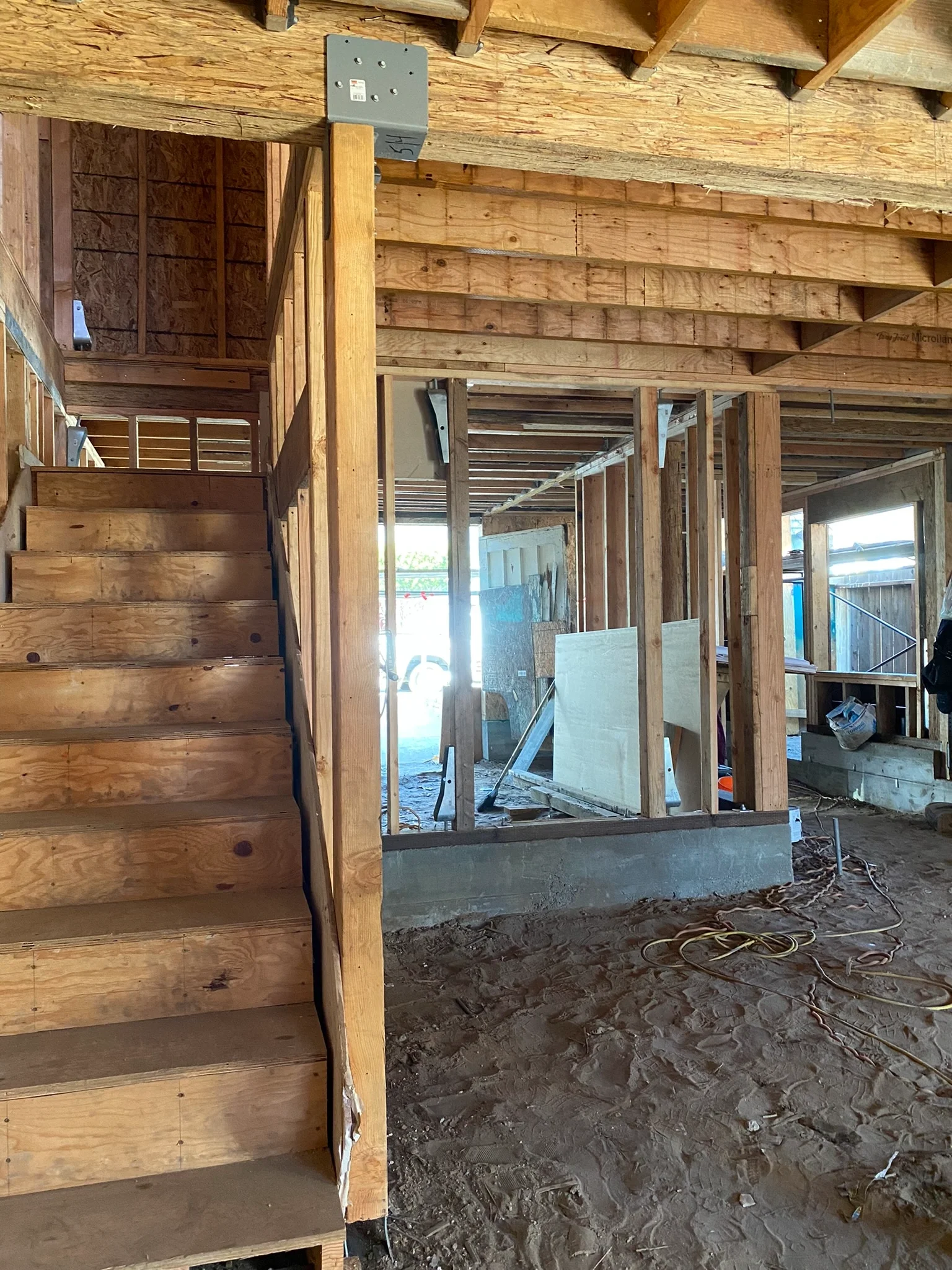 Two-story detached ADU interior framing corridor leading to exterior opening — San Francisco Bay Area general contractor