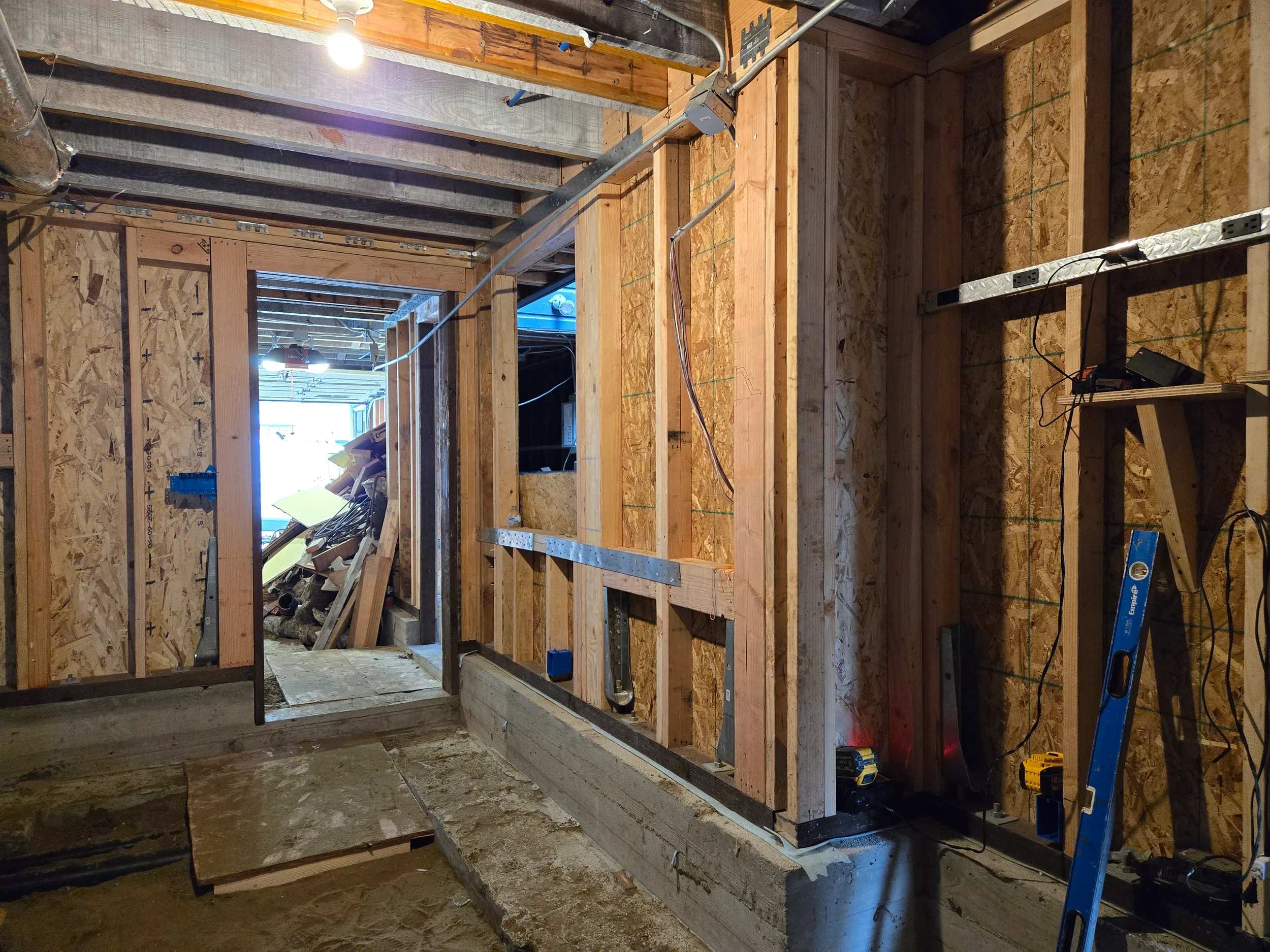 Framed corridor in crawlspace leading to exterior opening during conversion — San Francisco Bay Area general contractor