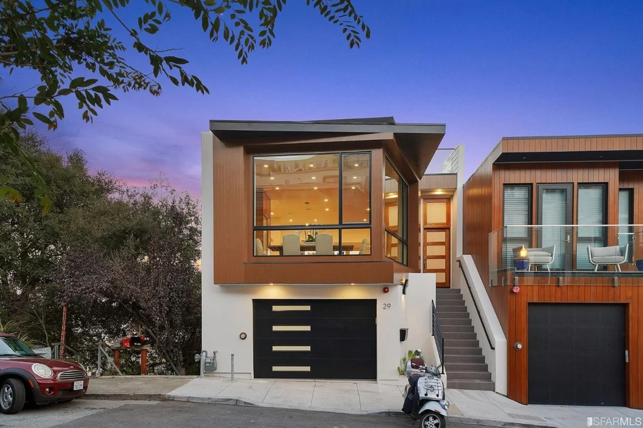 Modern exterior of vertical addition with cantilevered window box at dusk — San Francisco Bay Area general contractor