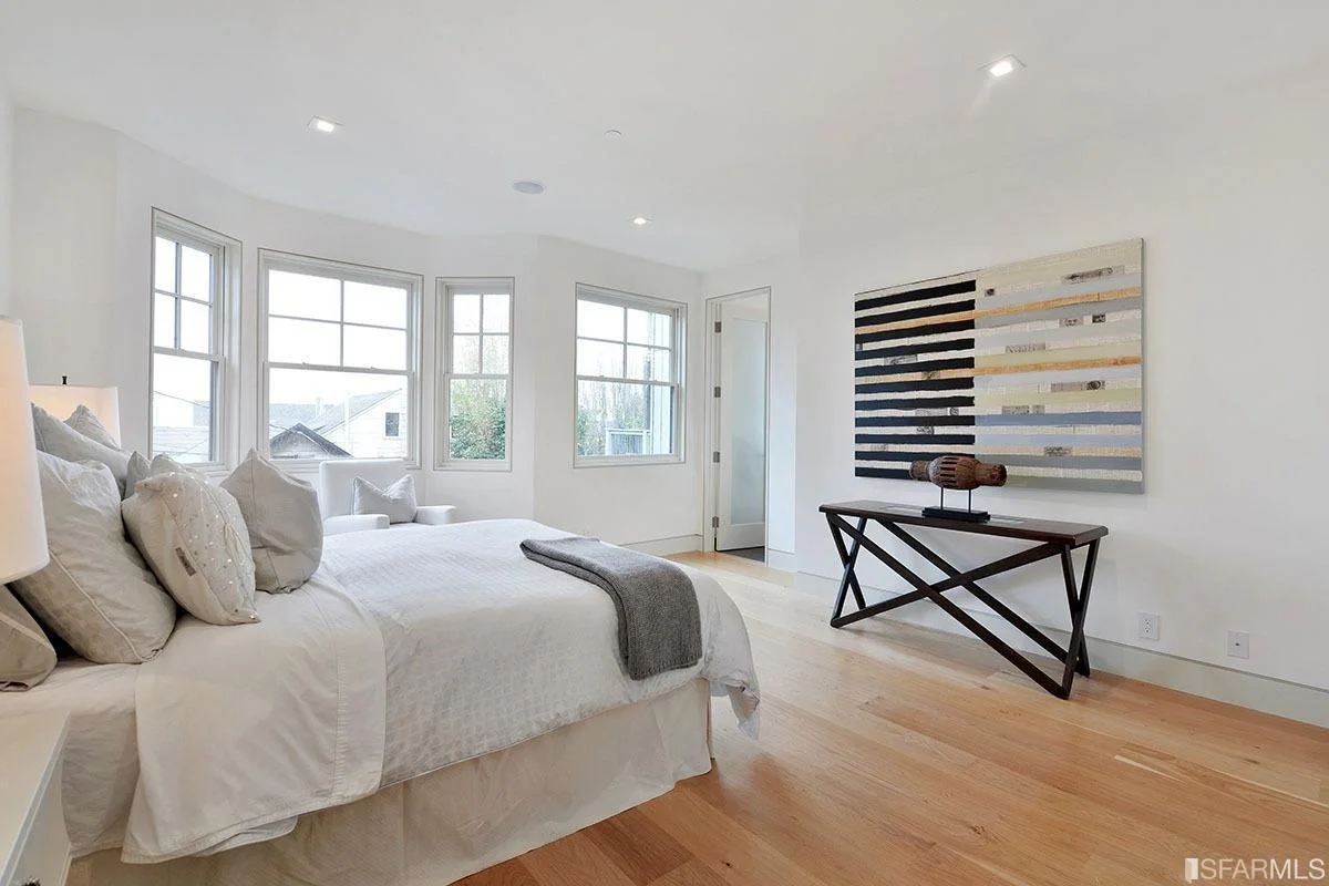 bedroom with corner windows, desk area, and hardwood flooring — San Francisco Bay Area general contractor