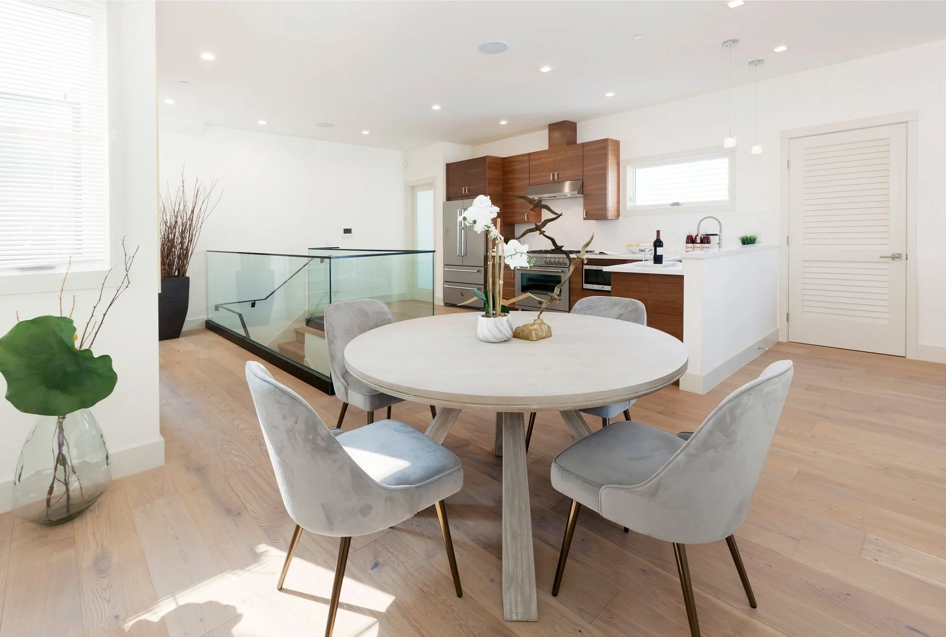 Dining area in San Francisco Bay Area condo remodel with round table, modern chairs, and open layout — general contractor