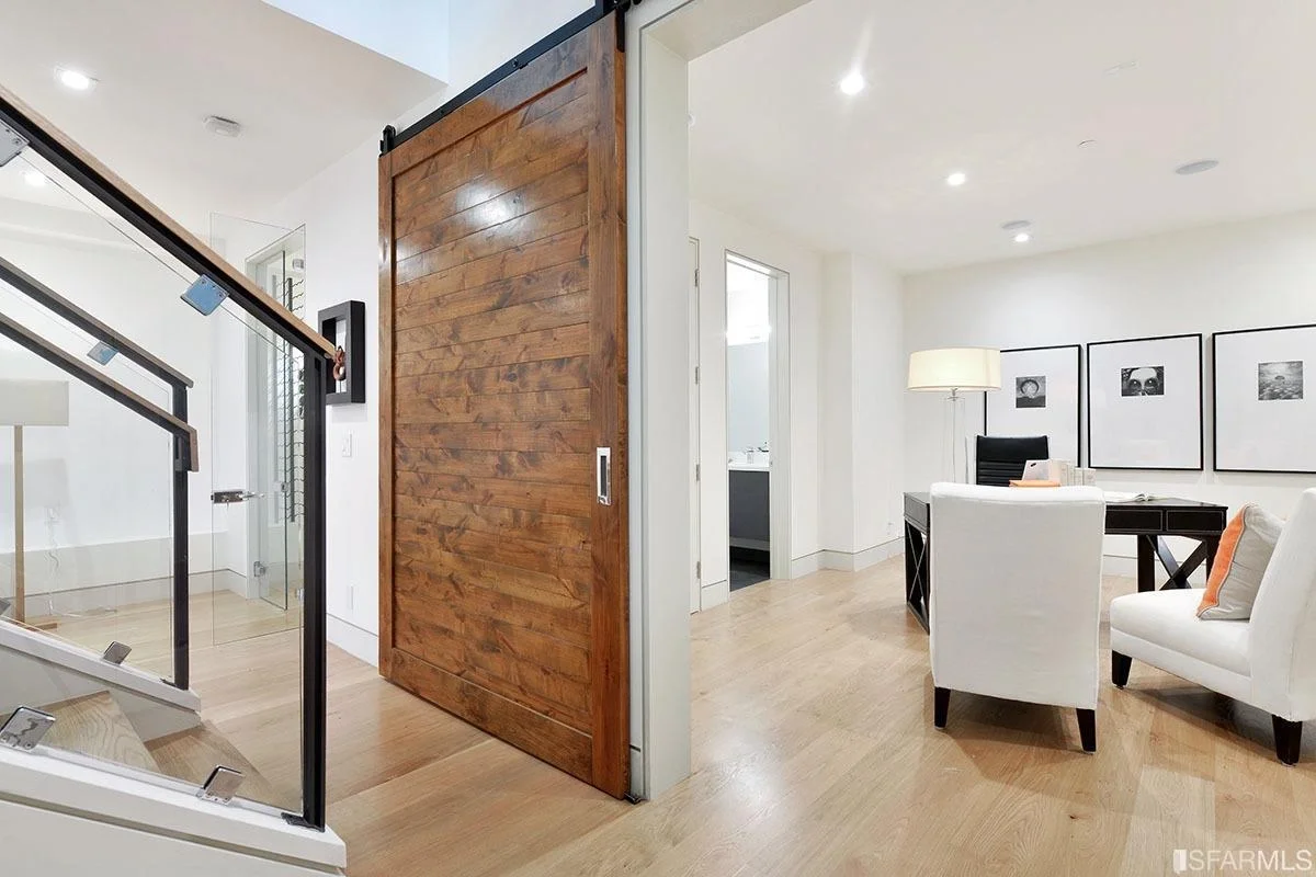 Entry hallway in vertical addition with wood accent door and recessed lighting — San Francisco Bay Area general contractor